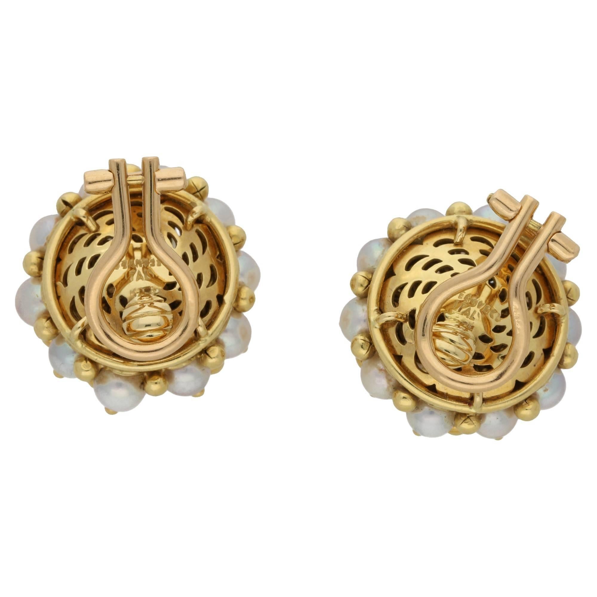 A pair of Italian Tiffany & Co. pearl and 18ct yellow gold cluster design ear clips. Comprising of eighteen fully drilled pearls on each ear clip separated by gold spheres. Stamped “Italy Tiffany and Co. 750”.