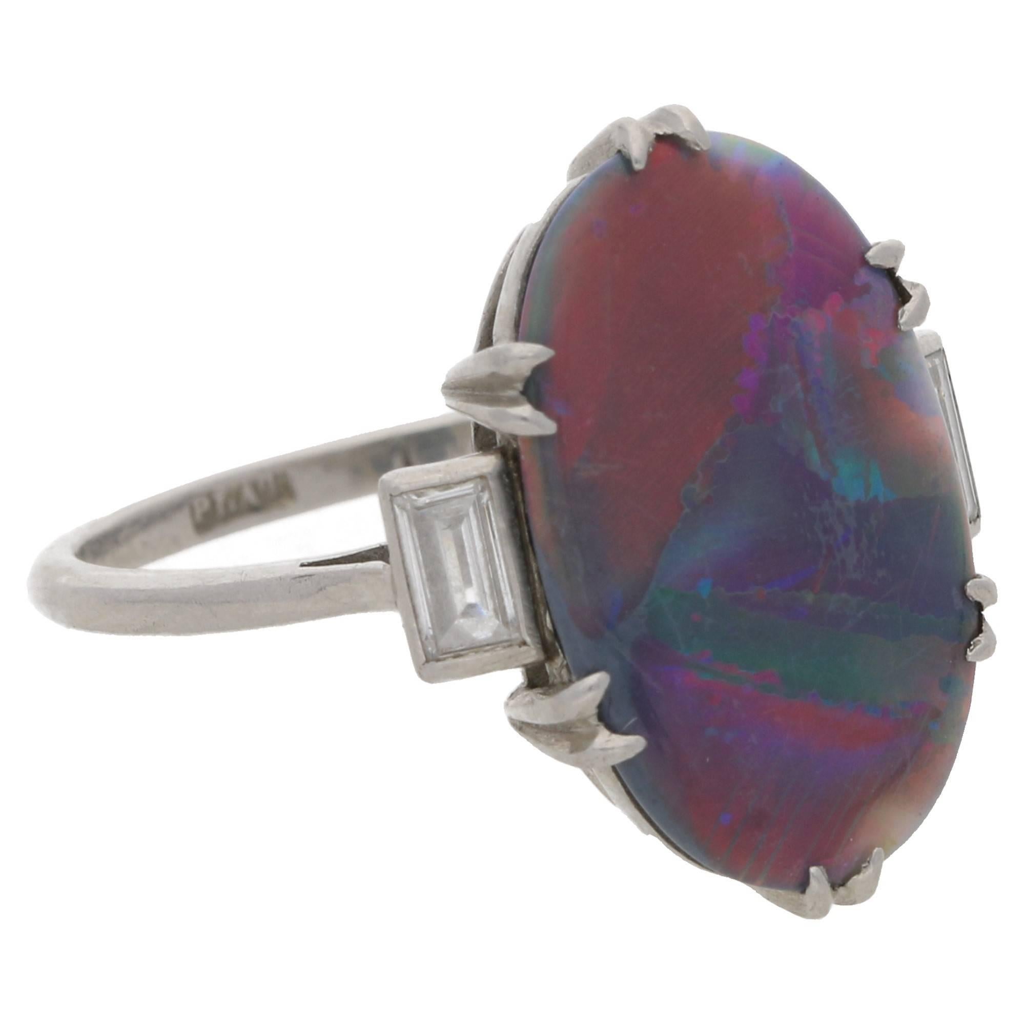 An impressive Art Deco harlequin black opal and diamond ring in platinum, circa 1935. The ring is set with an oval-shaped cabochon natural unenhanced harlequin black opal in an open-back double talon claw setting with approximately 1.50 carats,