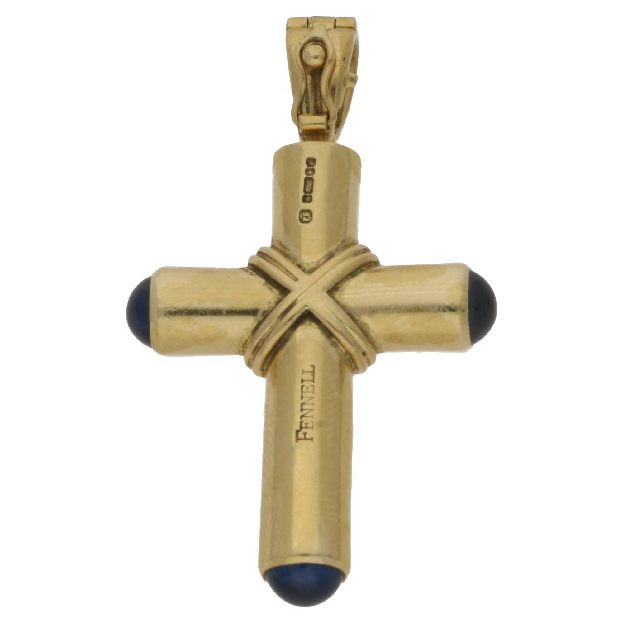 A chunky vintage 18k yellow gold Theo Fennell cross set with three cabochon sapphires. Measures 40mm x 26mm approximately.