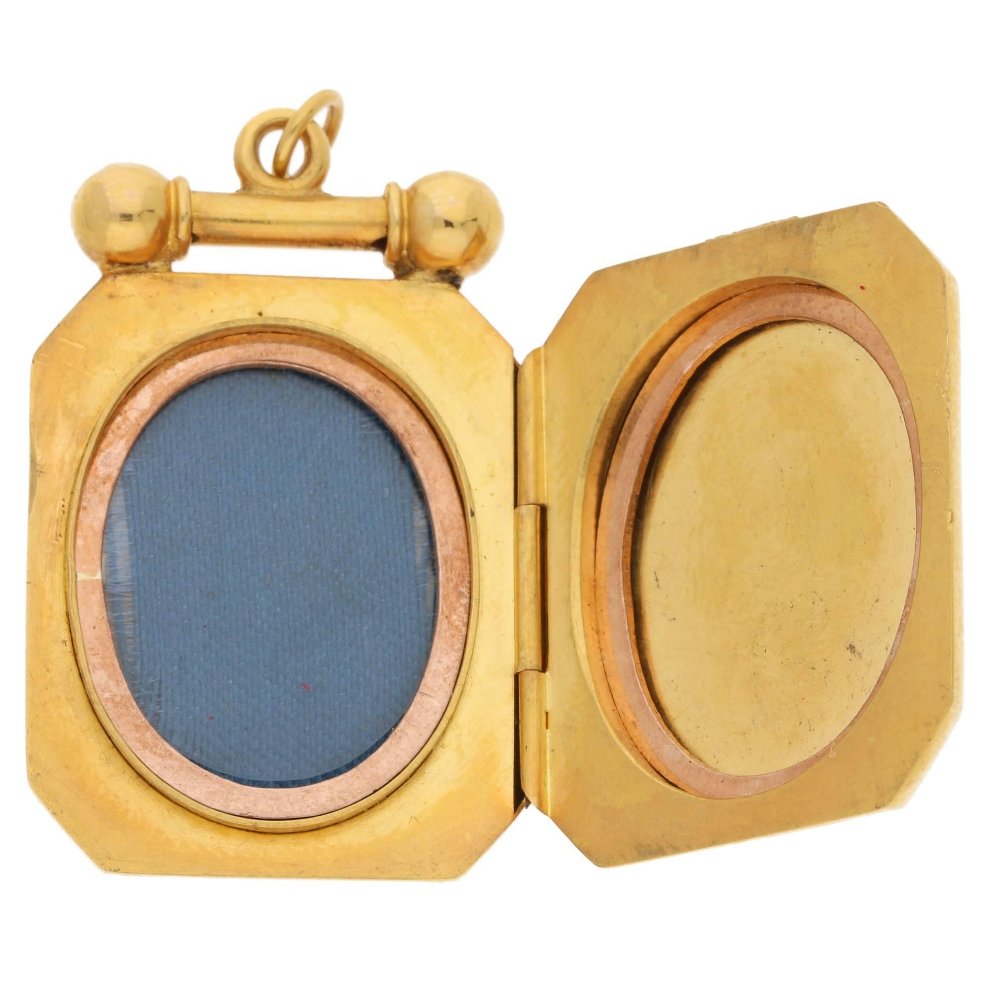 A Victorian unusually shaped 15k hallmarked yellow gold locket set with a diamond in the central motif. Diamond approximately 0.05cts. Opens to reveal two sections that would hold two small sentimental images. Clasp is very secure and in great