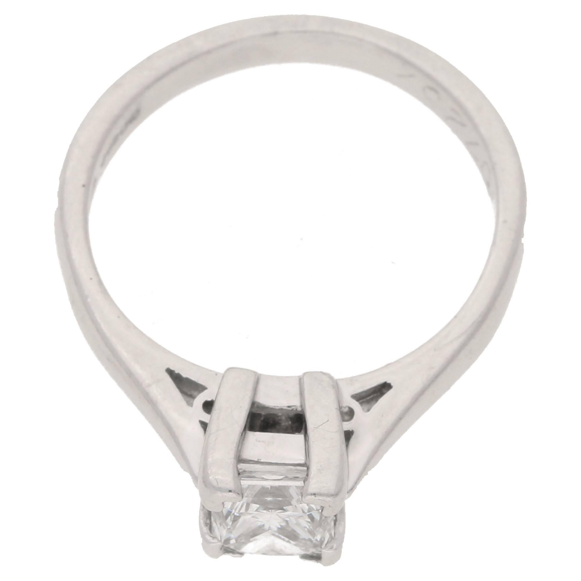 A platinum princess cut solitaire ring, featuring a 0.70ct G/H colour and VS clarity princess cut diamond set in a squared four claw double gallery setting to beautifully tapered shoulders and a plain polished shank. The ring is finger size I but