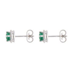 Contemporary 0.80ct Emerald and Diamond Halo Earrings