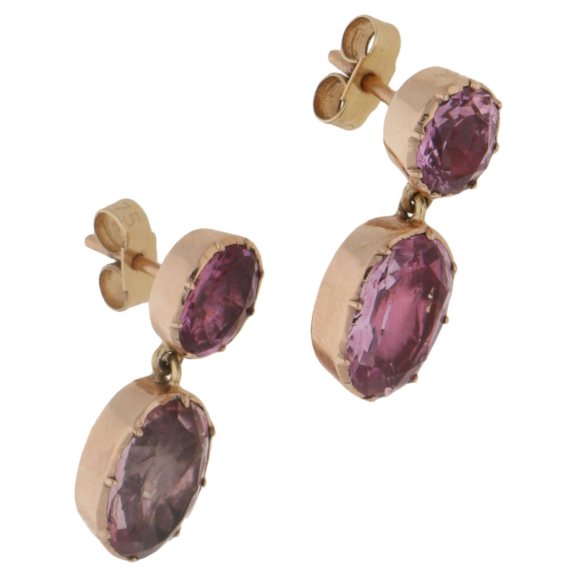 A pair of early Victorian pink topaz drop earrings. The earrings which date from around 1850 are comprised of two foil backed oval cut topaz stones, one suspended underneath the other. They are each set in a closed back setting with delicate claw
