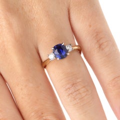 Anello contemporaneo con tre pietre: zaffiro da 1,68 carati con taglio a cuscino e diamanti