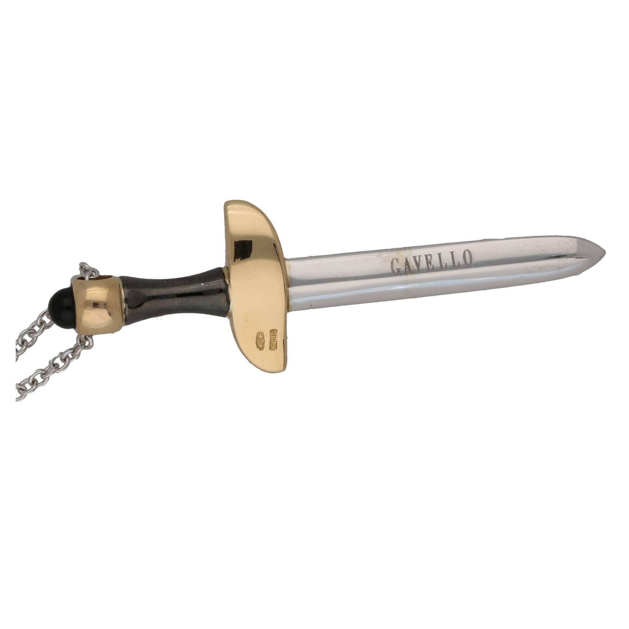 A diamond and gem-set sword pendant by Gavello. The sword is formed by a  brilliant-cut diamond blade, with ruby accent cross guard and an onyx handle and pommel. The sword is suspended from a trace-link chain. Signed Gavello. Estimated total