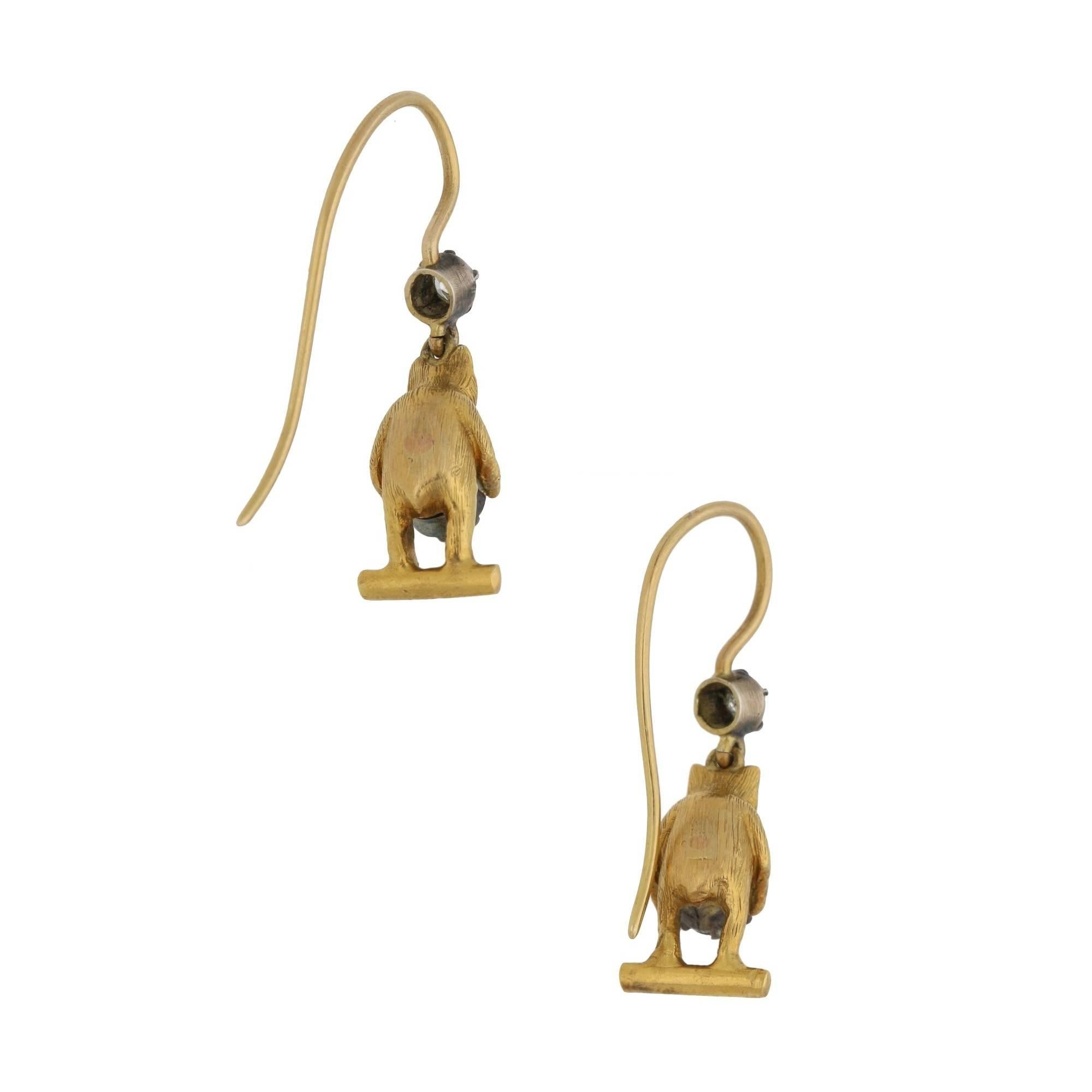 A beautiful pair of late Victorian bear drop earrings set in 15k yellow gold. The pair are beautifully hand-finished with brushed detailing to the face and body and each hold a single old European cut diamond in their paws. Furthermore, each bear is
