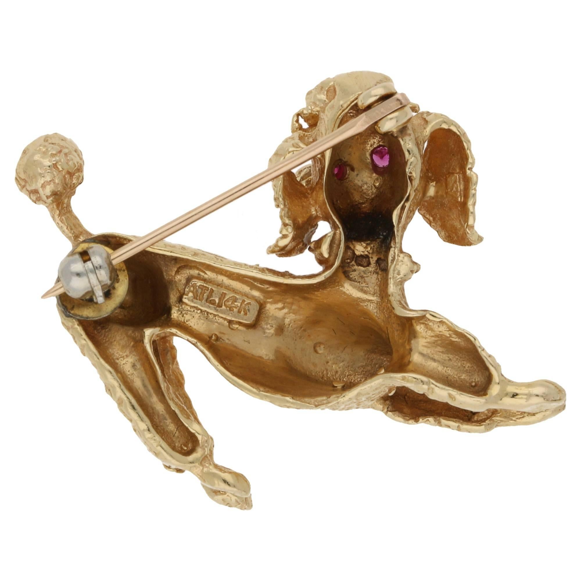 A lifelike 1950's 14ct yellow gold poodle brooch with round faceted ruby eyes. Contact us if you would like more photos or information on this piece. 