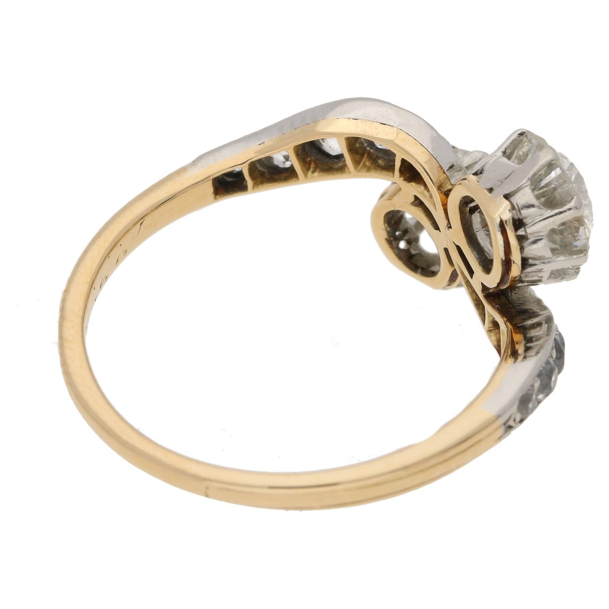 A double diamond twist ring featuring two claw set Old European cut diamonds on a diamond  grain set twist in platinum to an 18ct yellow gold band. The central two diamonds are estimated as H/I colour, Vs clarity and weighing 0.80ct and 0.77ct