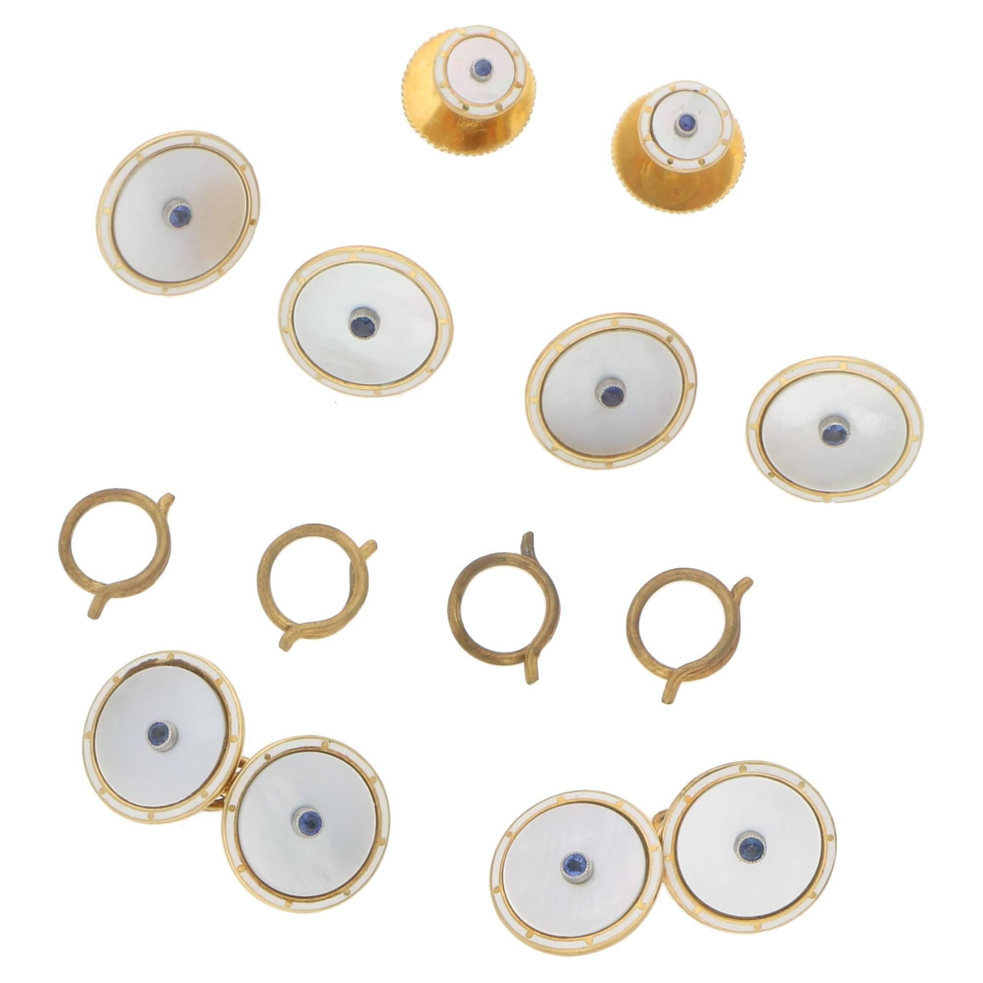 An immaculate Victorian dress set. This set is complete with all its original fittingsl The set is made from 18 carat yellow gold. The studs and links are set with fine mother of pearl discs set with a rub-over set sapphire in the centre. The links