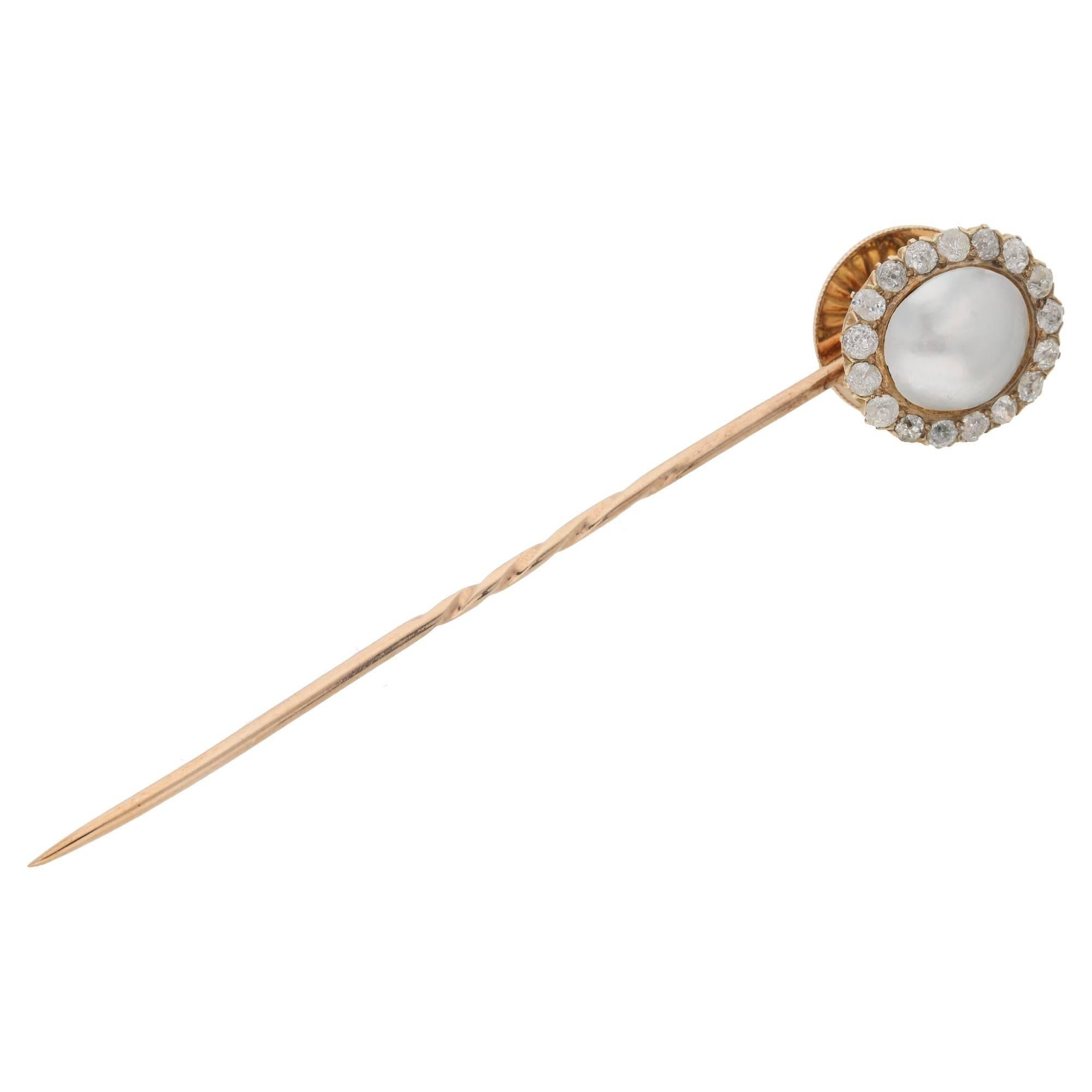 A fine Victorian pearl and diamond stick pin with detachable head. The head of the pin is formed of an oval blister pearl set to the centre with seventeen old cut diamond forming outer detail. The pin can be unscrewed from its metal 'stick' to be