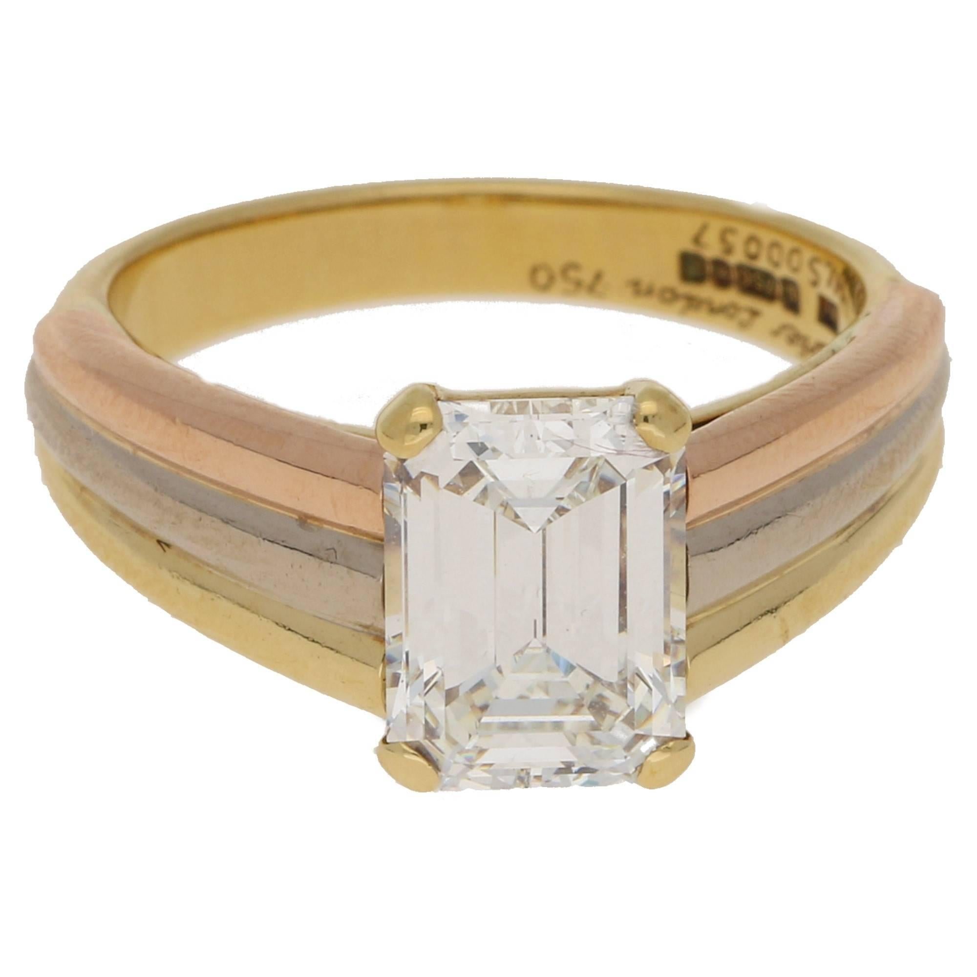 A vintage Cartier single stone ring featuring a stunningly well-proportioned and excellent cut emerald cut diamond independently certified as 2.25ct J colour VVs1 clarity, set in a four claw double gallery setting to tapered shoulders that are