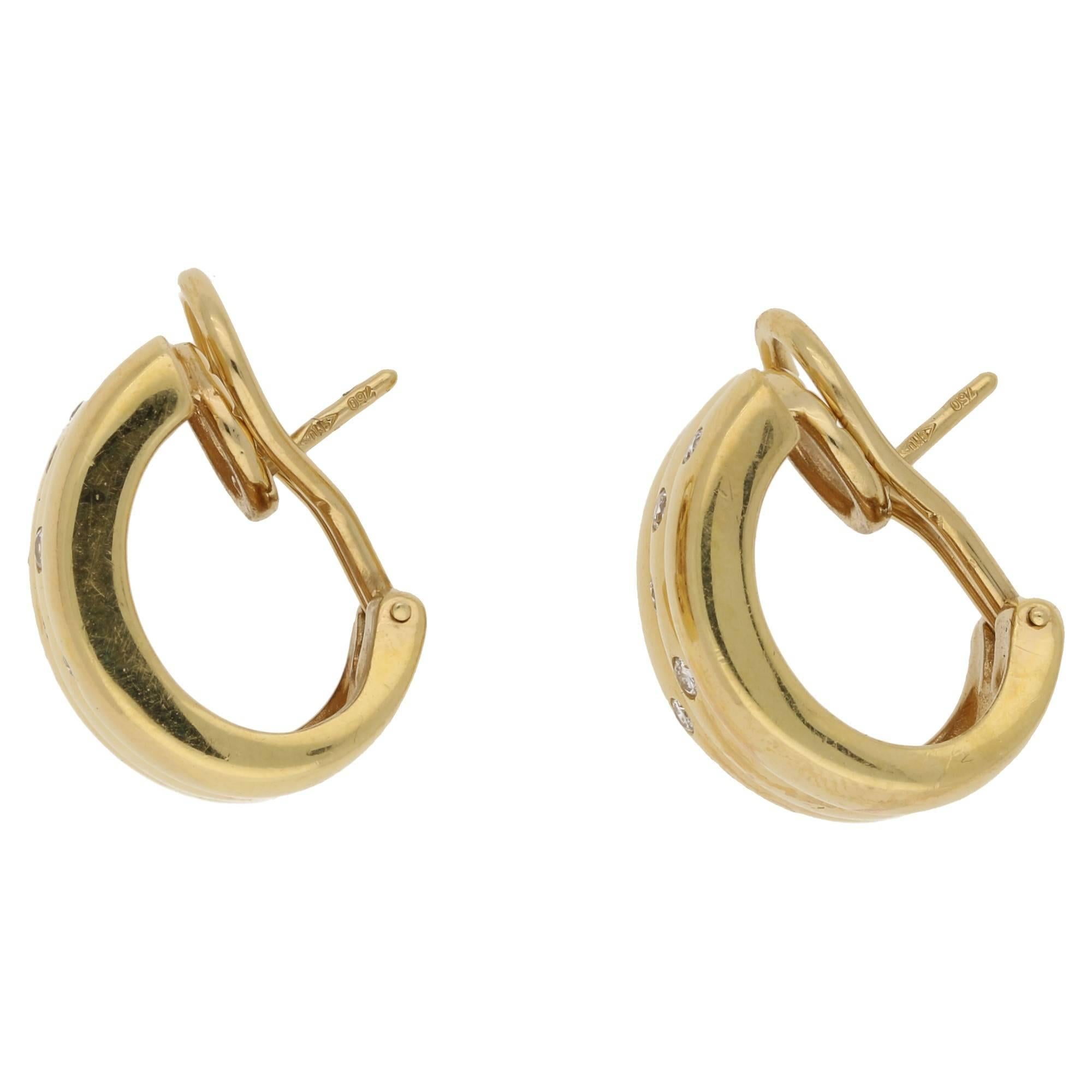 A chunky vintage pair of 18ct gold earrings set with interspersed round brilliant diamonds. On post and clip fittings.