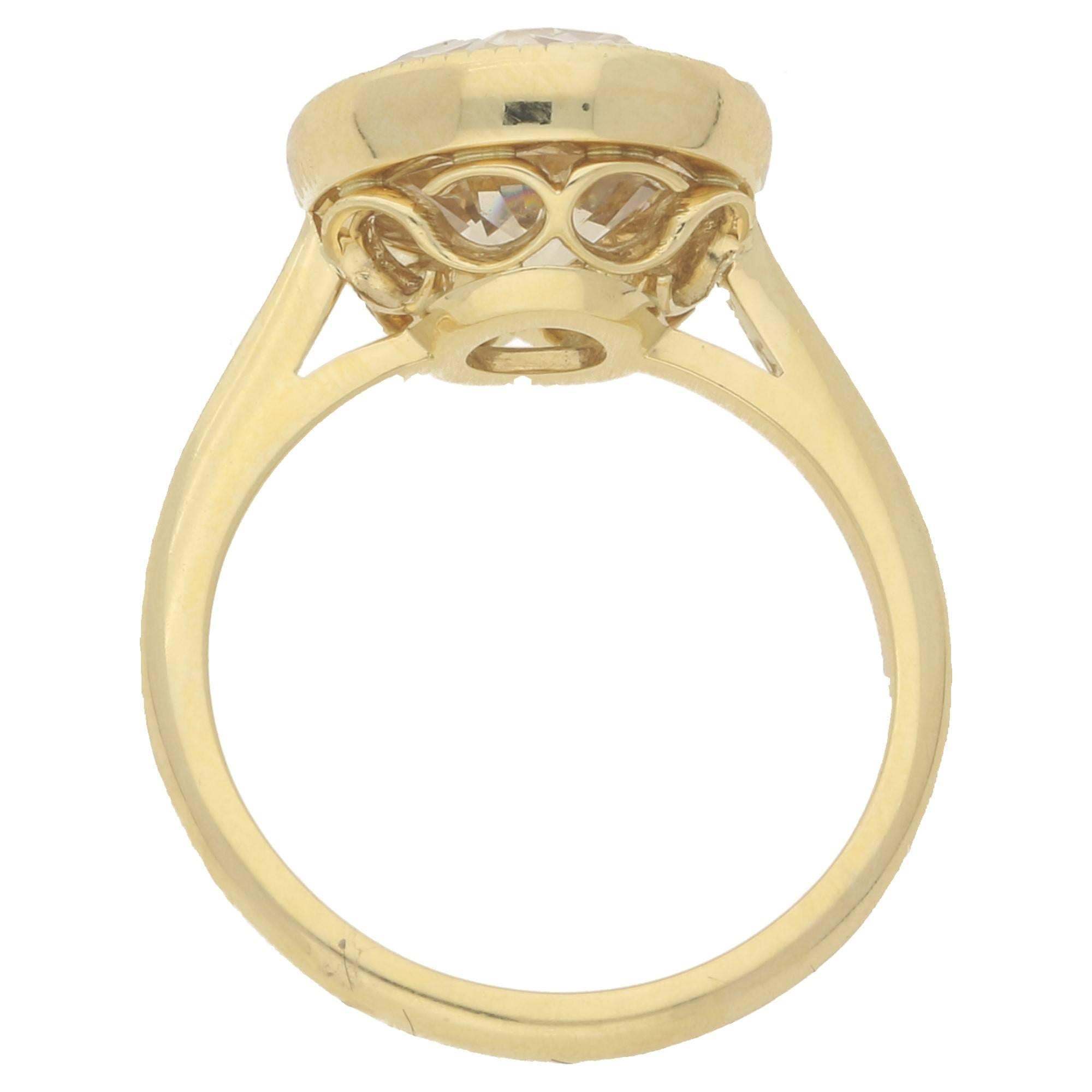 A modern 18ct yellow gold solitaire ring, featuring a round re-faceted Old European cut diamond estimated as 4.46cts, K/L colour and Si clarity set in a rubover setting with millegrain detailing and an openwork handmade setting underneath to a