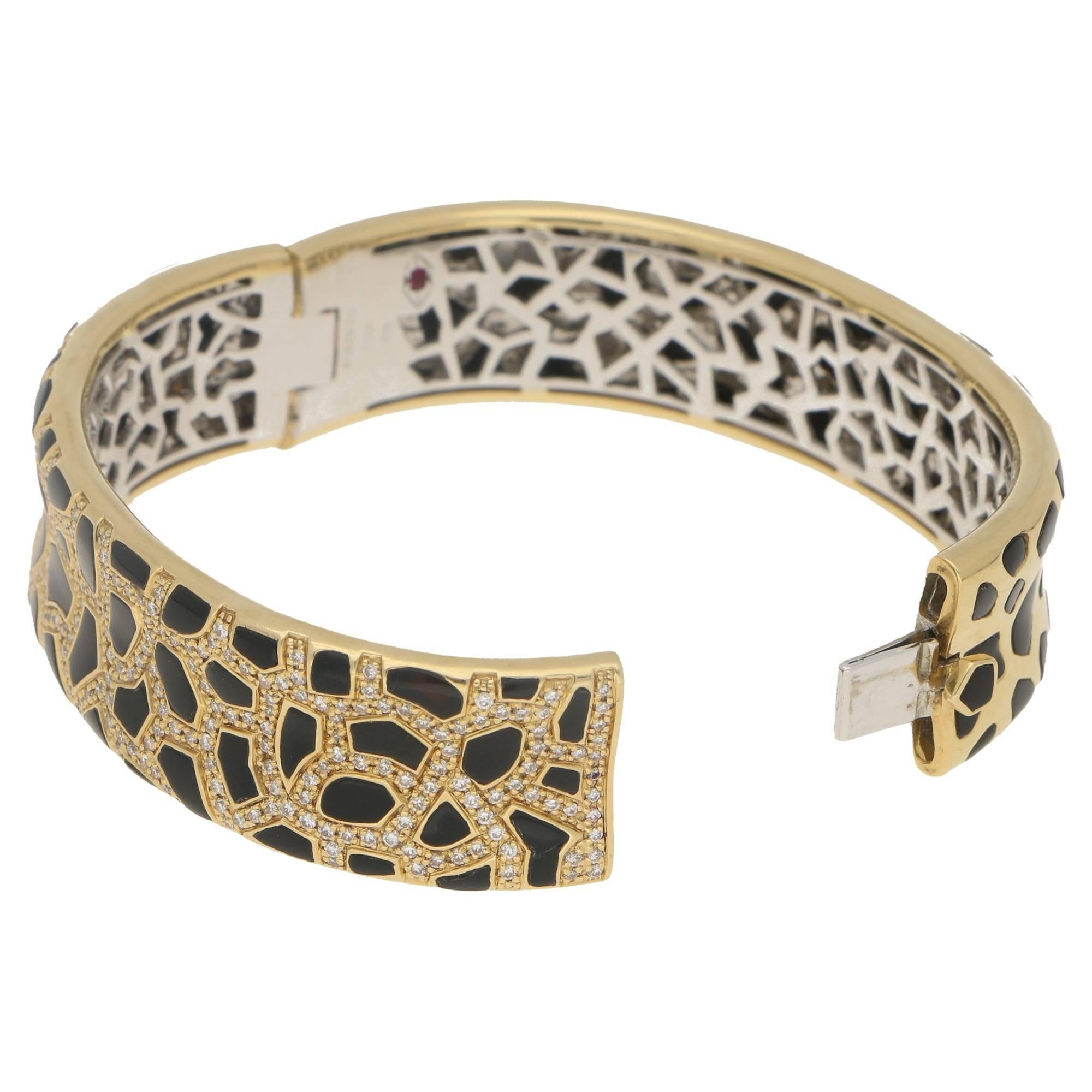 A stunning leopard print design Roberto Coin 18ct yellow gold hinged bangle, set with diamonds and onyx from his Animalier collection. The onyx is set into the gold as leopard spots and on the front the space in between the onyx is pave set with