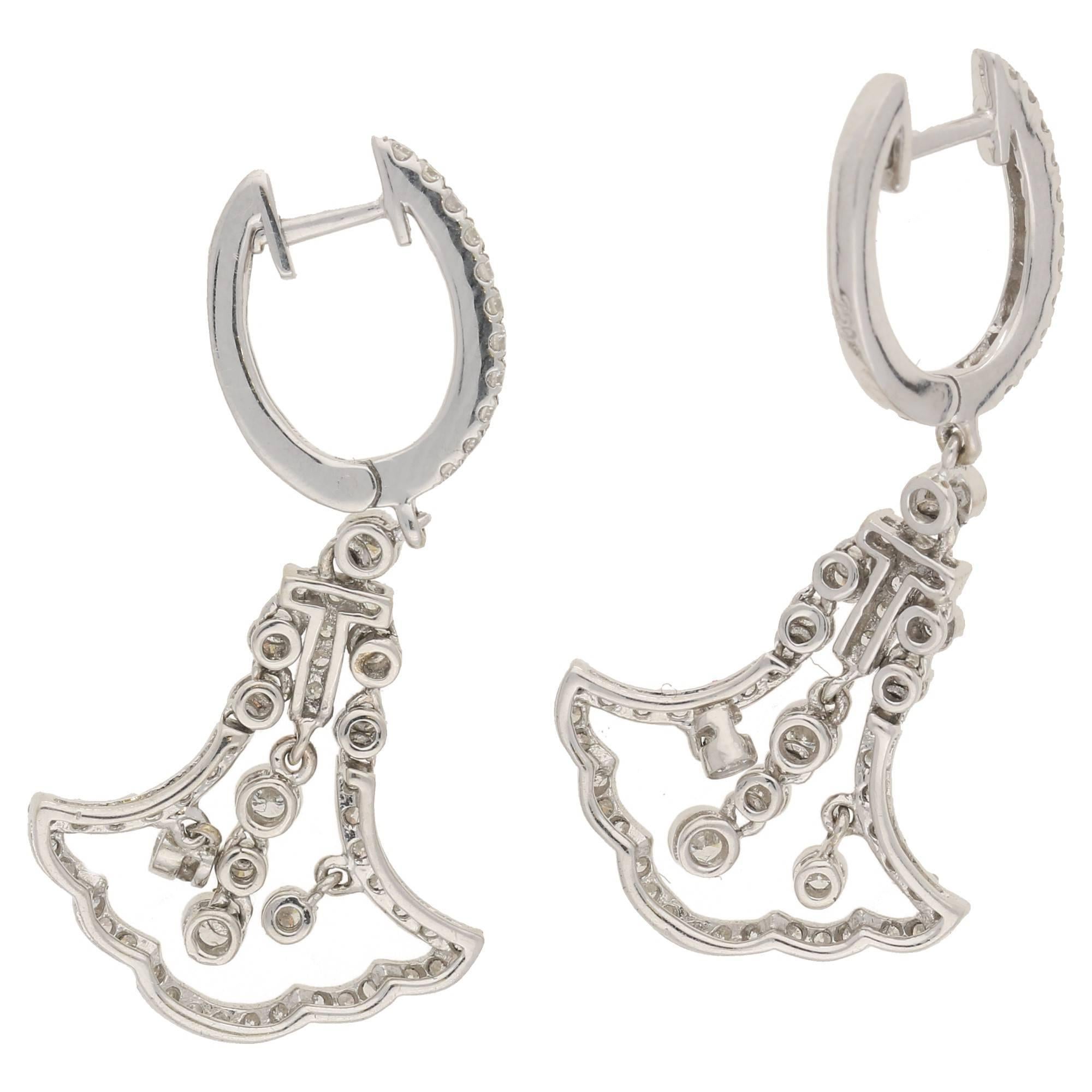 Fine pair of round brilliant diamond set drop earrings, in 18k white gold. These earrings are set with 114 diamonds in total, of approximately 0.86cts in diamond weight in total. The articulation in all sections allow these earrings movement which