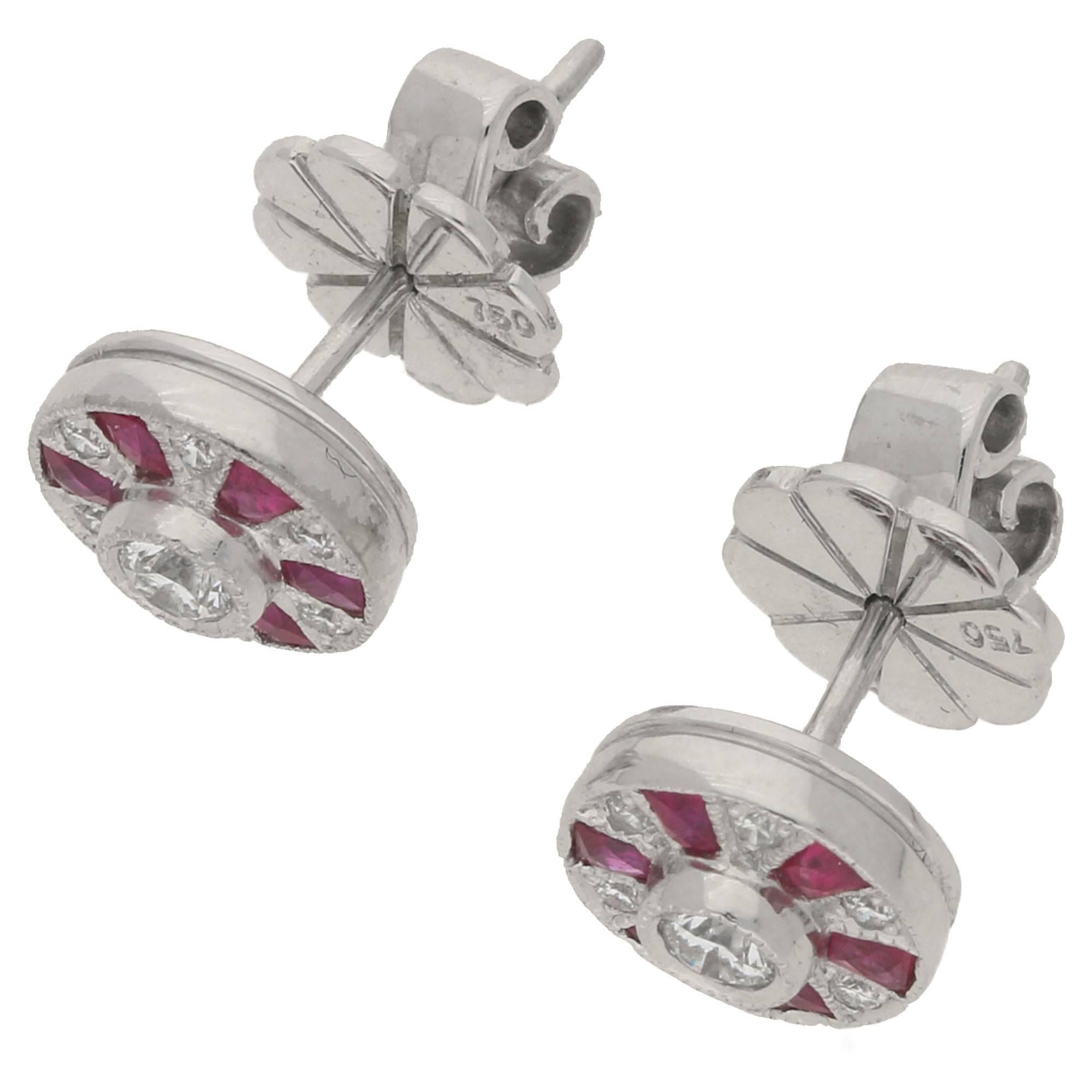 The studs are in 18ct white gold and are set with 0.55cts of ruby and 0.23 carats of diamond. Fitted with post and butterfly backs.