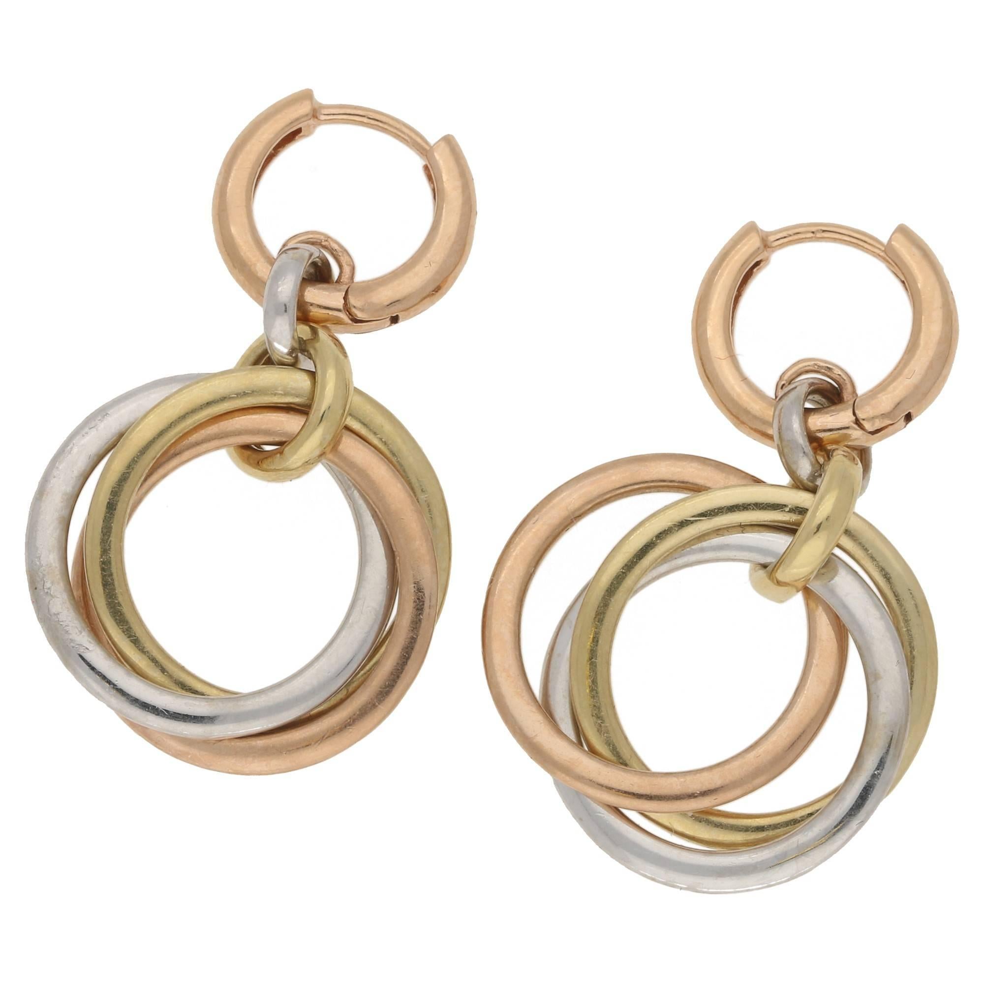 A wonderful pair of diamond set tri-coloured 14ct gold circlet earrings. Each earring consists of three gold circlets hanging intertwined from a yellow gold bale connected to a white gold bale terminating in a rose gold hinged full hoop with