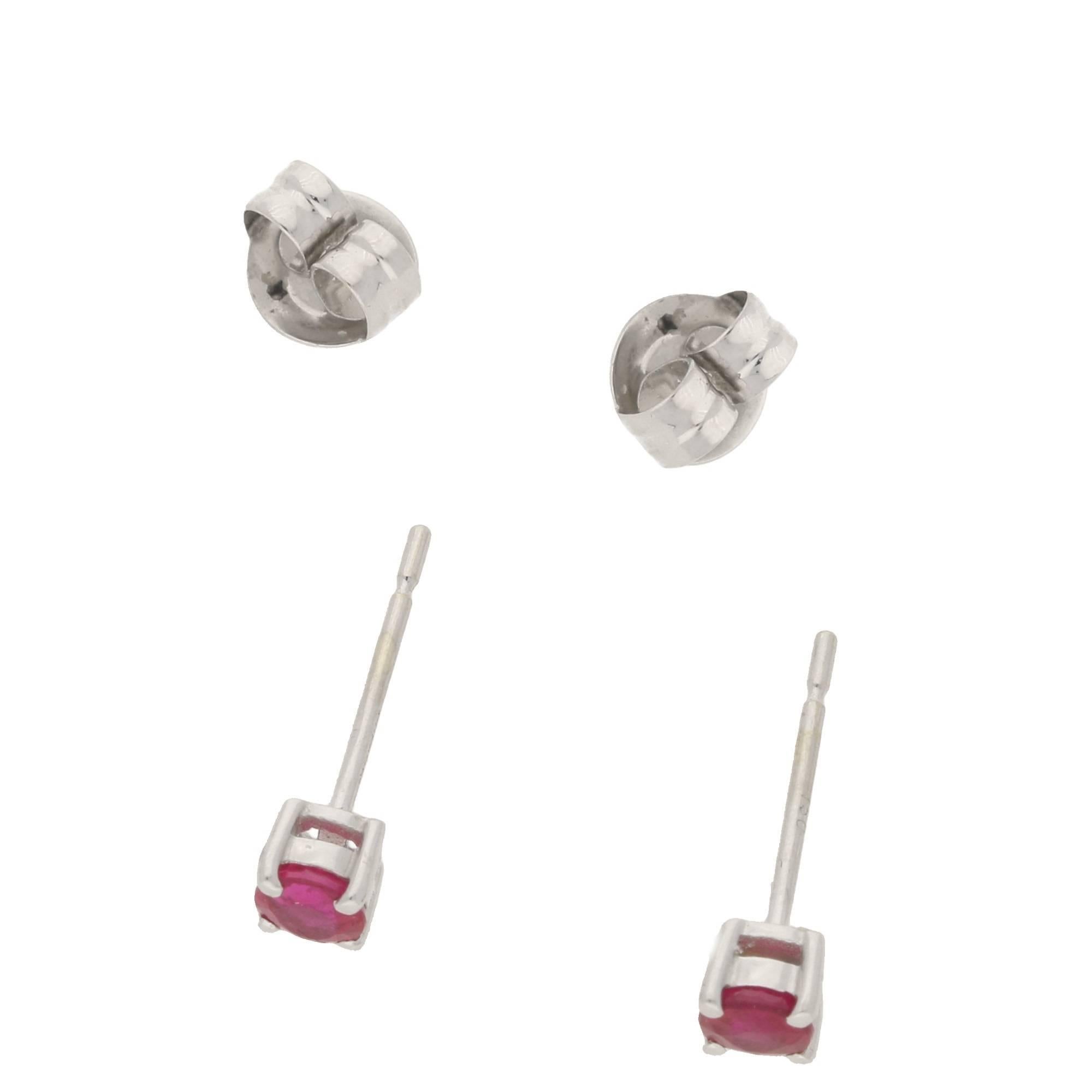 A fine pair of ruby stud earrings, totaling 0.54cts. Set in a classic 4 claw basket setting in 18ct white gold. On a post and butterfly fitting.
