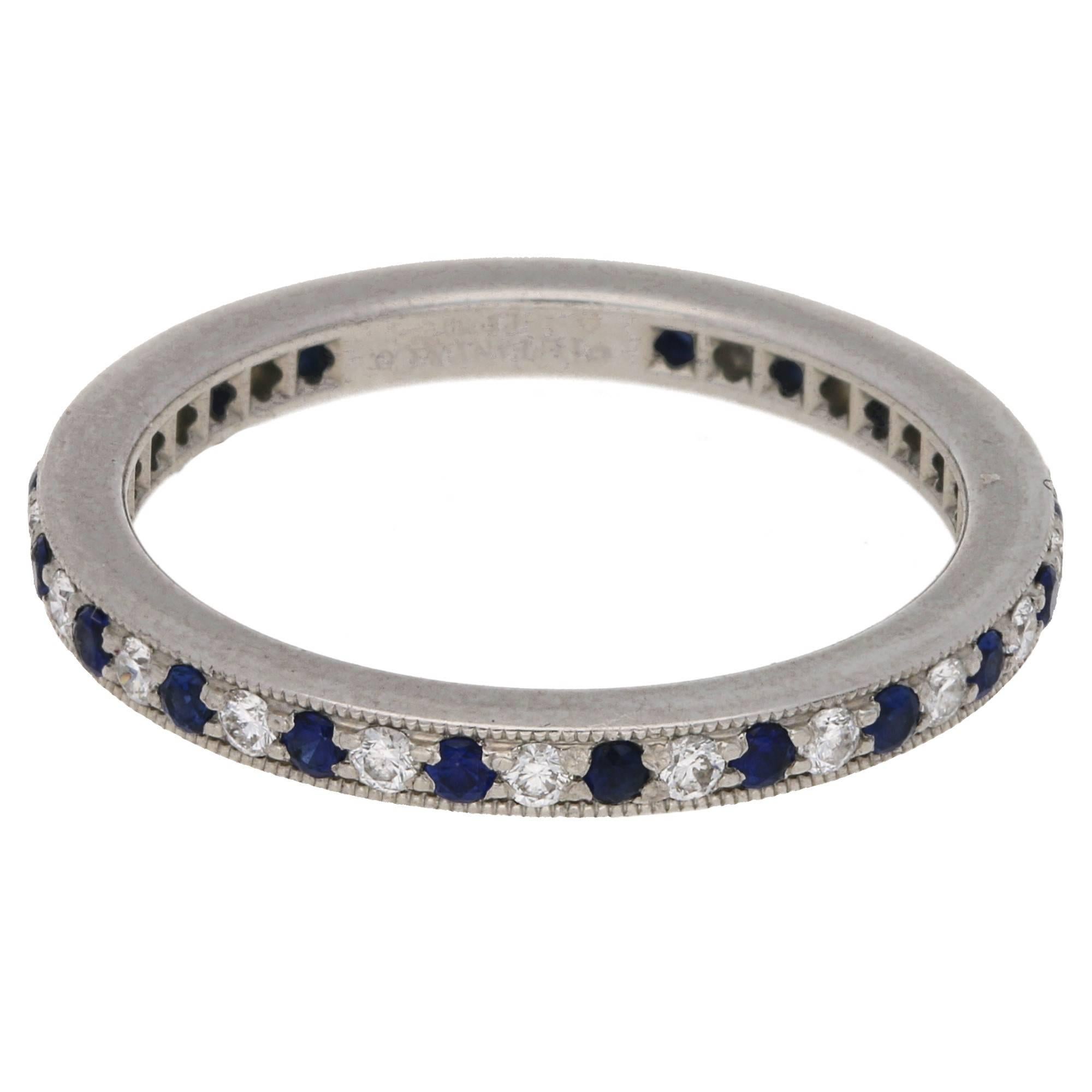 A fun and wearable vintage Tiffany and co eternity band. This contemporary ring evokes the glamour of the Edwardian period. Ring in platinum with a mille-grain edge and a full circle of bead-set round brilliant diamonds and sapphires. 2 mm wide.