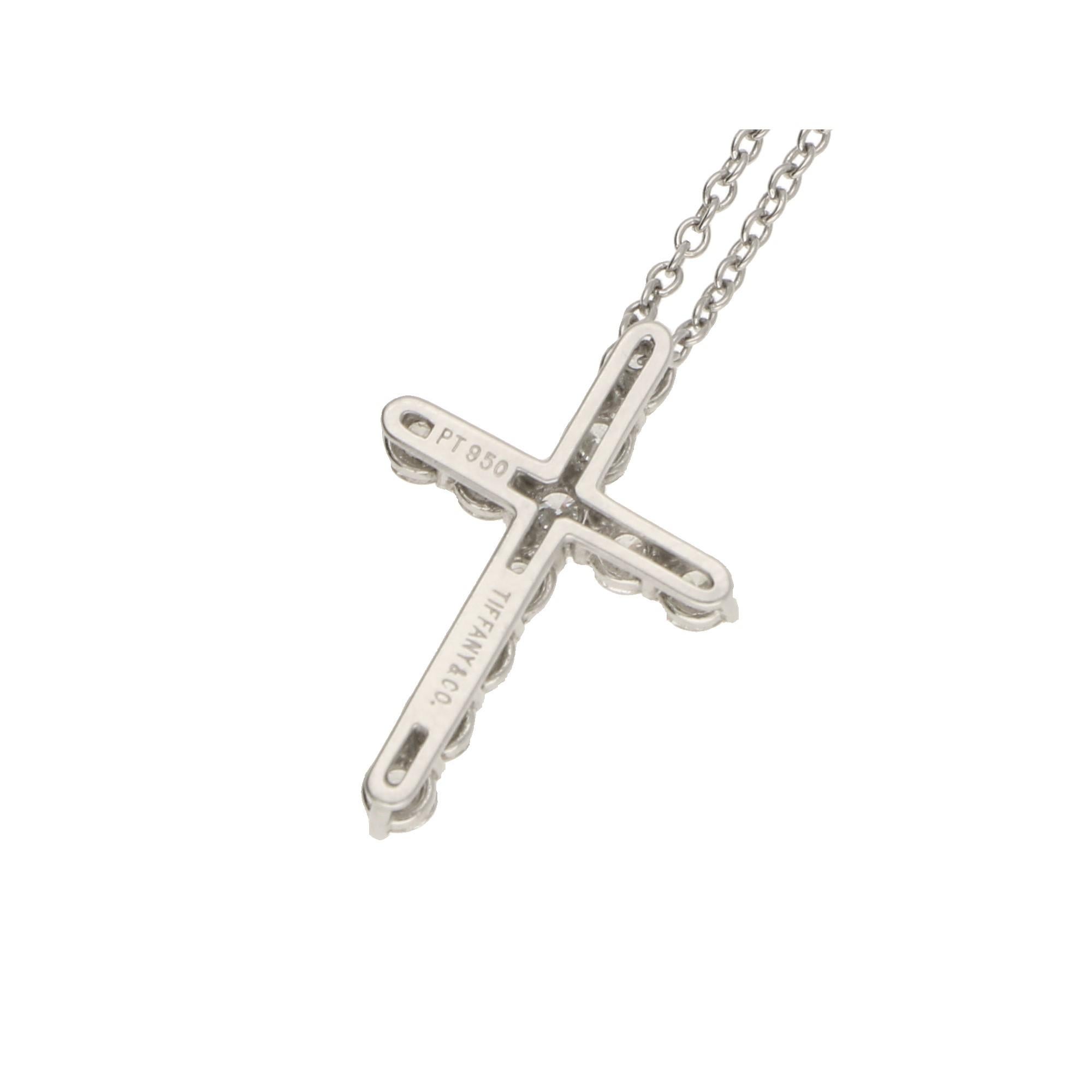 An elegant Tiffany & Co diamond cross pendant in platinum, featuring a platinum cross shared-claw-set throughout with eleven round brilliant-cut diamonds with a combined weight of 0.42 carats, F/G colour (assessed), VS clarity (assessed), fitted on