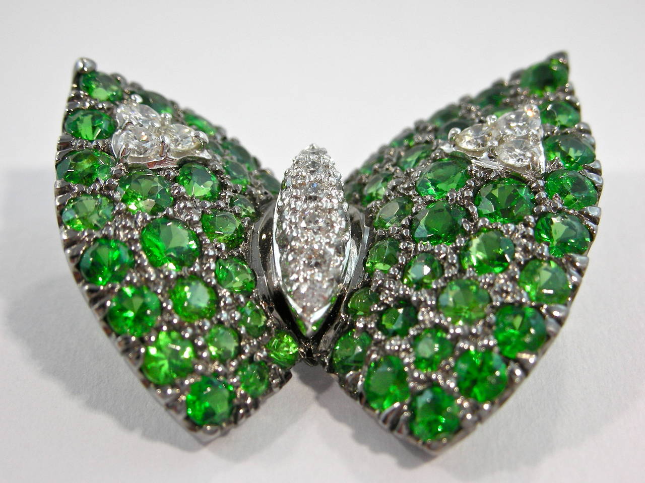 Jona design collection, hand crafted in Italy, 18k white gold butterfly brooch, set with 0.32carats of white diamonds and 4.16 carats of Tsavorite with black rhodium finish.
All Jona jewelry is new and has never been previously owned or worn. Each