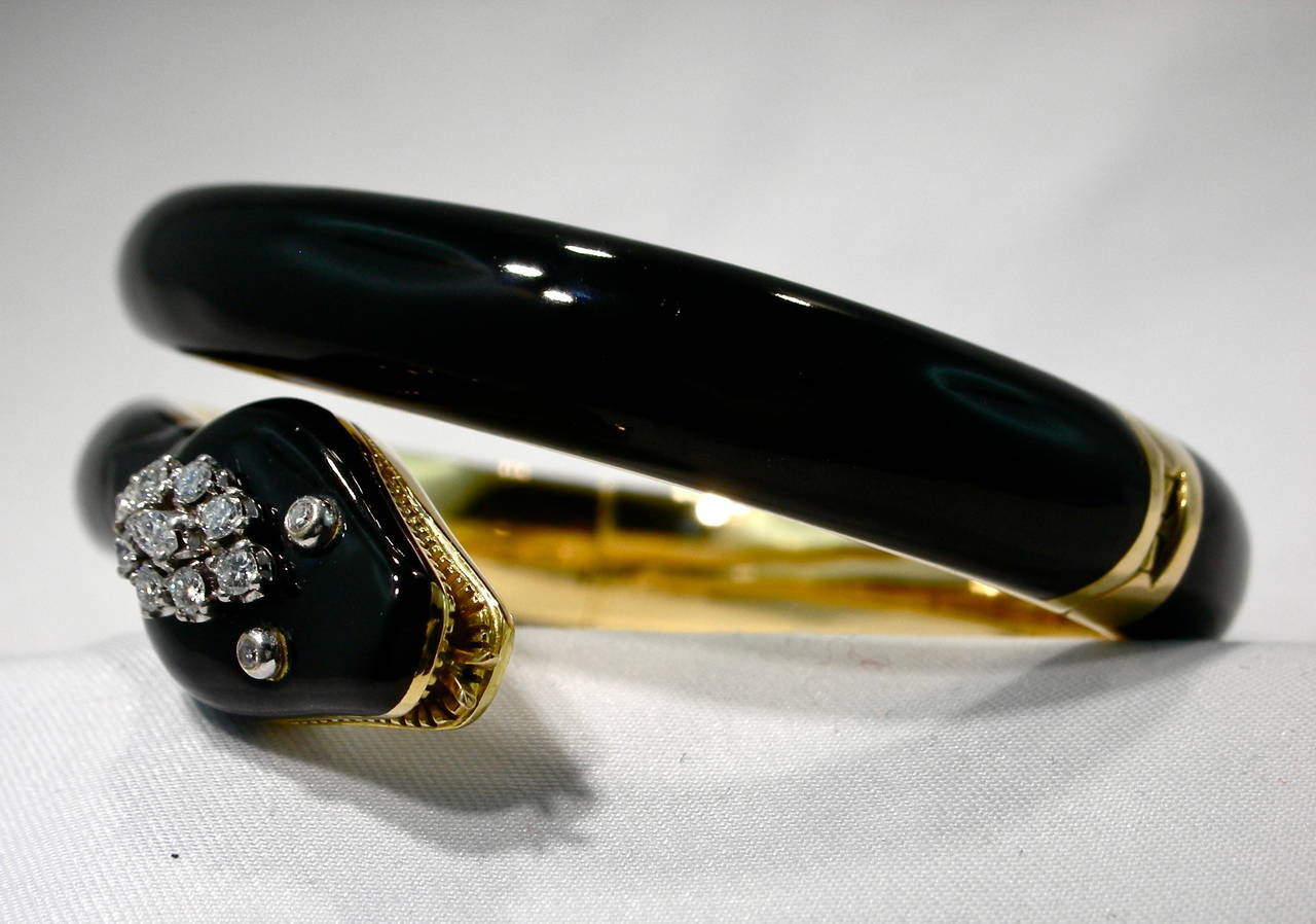 Black enamel 18 karat solid yellow gold hinged bangle bracelet. 

8 round cut diamonds, approx. total weight  .24ct. G, VS2
1 marquise cut approx.  .10 ct. G, VS2
2 round cut diamonds  approx. total weight  .02ct. G, VS2