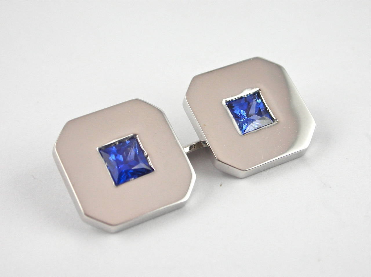 Jona design collection, 18 karat white gold cufflinks set with square cut blue sapphires weighing 0.58 carats. Hand made in Italy, stamped Jona.
Measurements: 12.58 x 12.58mm
All Jona jewelry is new and has never been previously owned or worn. Each
