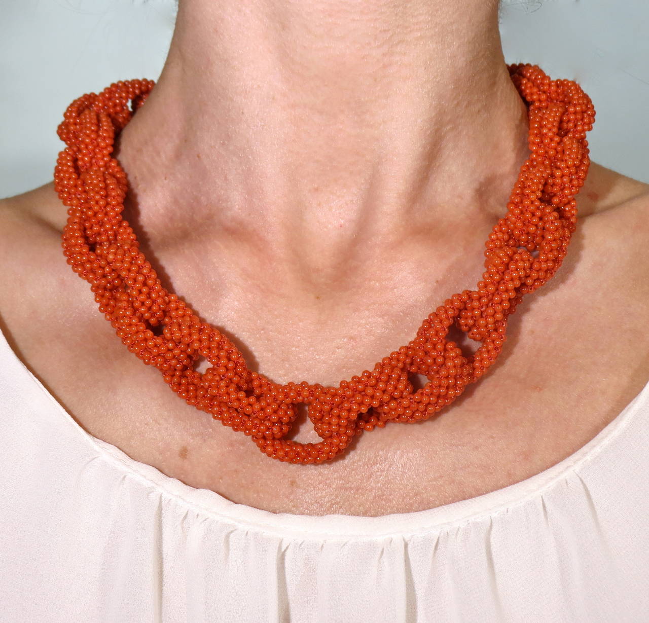 Mediterranean coral necklace by Jona, 50cm long made of small coral beads hand knotted as a link chain with a 18 karat yellow gold clasp.
A matching bracelet is available.

All of our jewelry is new and has never been previously owned or worn.
