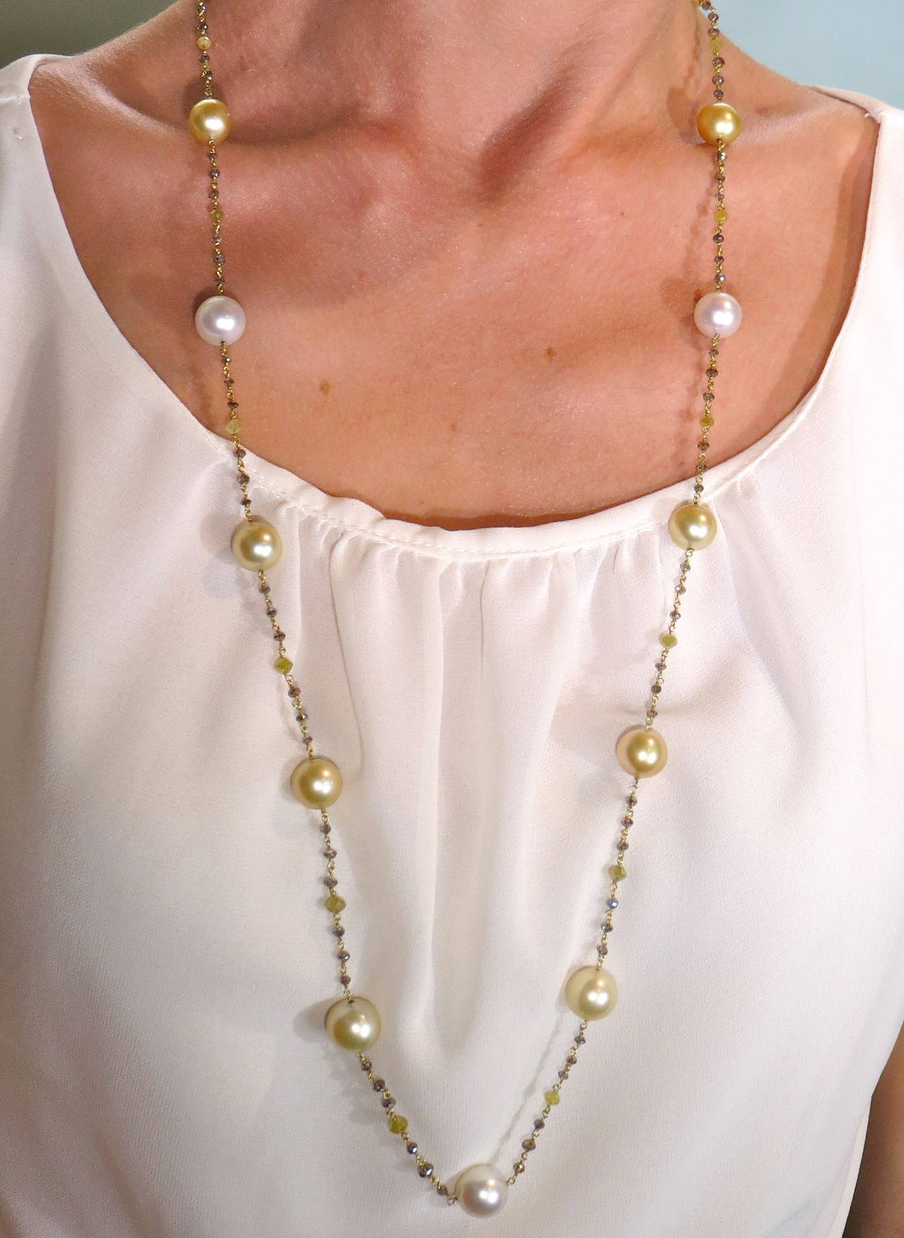 Jona design collection, 82cm long sautoir necklace, adorned with 15 white and gold South Sea pearls, with a diameter comprising from 11.30mm to 12.70mm and briolette-cut fancy yellow and champagne diamonds, weighing  20.10 carats in total. Hand