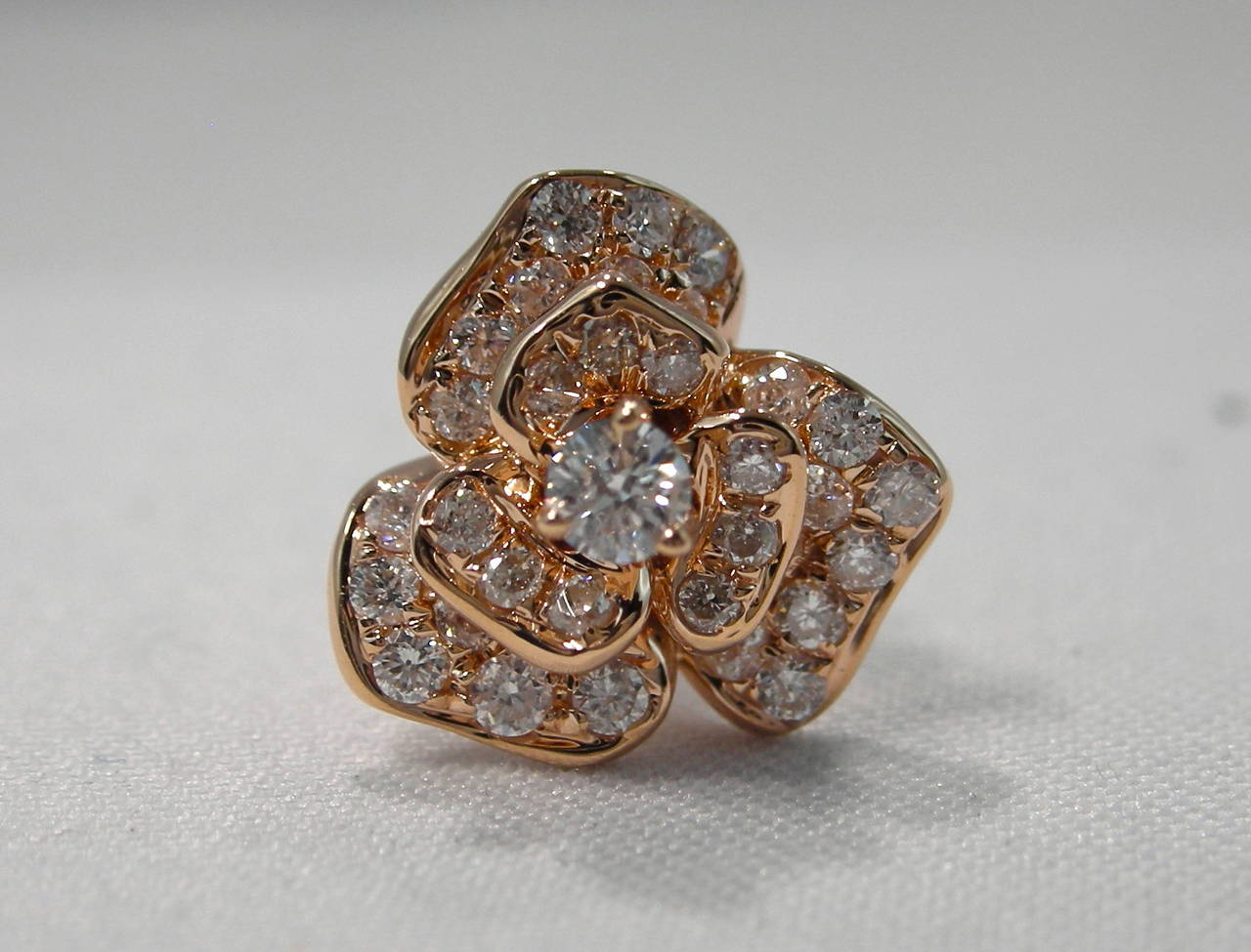 Jona design collection, 18 Karat rose gold, pair of roses stud earrings, set with 0.51 carats of G color, VVS1 clarity white diamonds. Crafted in Italy, signed Jona.

All of our jewelry is new and has never been previously owned or worn.