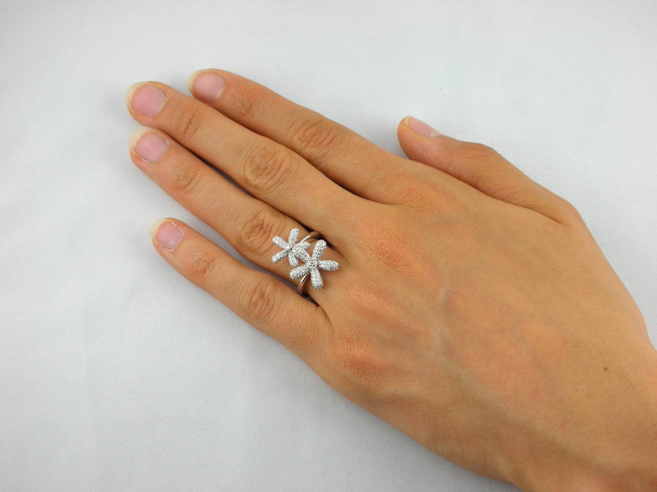 Jona design collection, hand crafted in Italy,18 karat white gold, diamond pavé daisy ring, set with 1 carat of white diamonds, F color, VVS1 clarity. US size 6.5
All Jona jewelry is new and has never been previously owned or worn. Each item will
