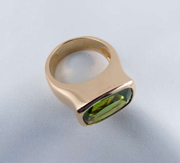 18k rose gold ring with cushion cut  peridot weighing 6.53 carats; seize 6.5 (can be sized).

All of our jewelry is new and has never been previously owned or worn.
