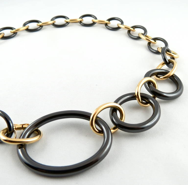 Jona design collection, alternating 18k yellow gold and black high-tech
ceramic oval chain necklace.
Dimensions: L=49cm, H = 3.4, W = 1.8, D = 0.5 

With a hardness approaching that of diamond, high-tech ceramic is a highly
scratch-resistant