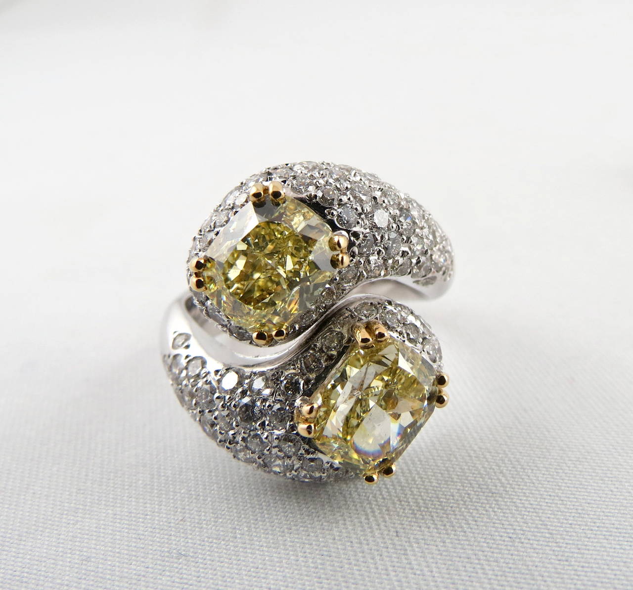 Magnificent Hand Crafted in Italy Crossover Natural Fancy Yellow Diamond Ring by Jona, Featuring Natural Fancy Yellow GIA Certified Diamonds.

One diamond is 
Color: Fancy Yellow 
Size: 1.86ct,
Clarity: VVS2
Cut: Cushion Modified