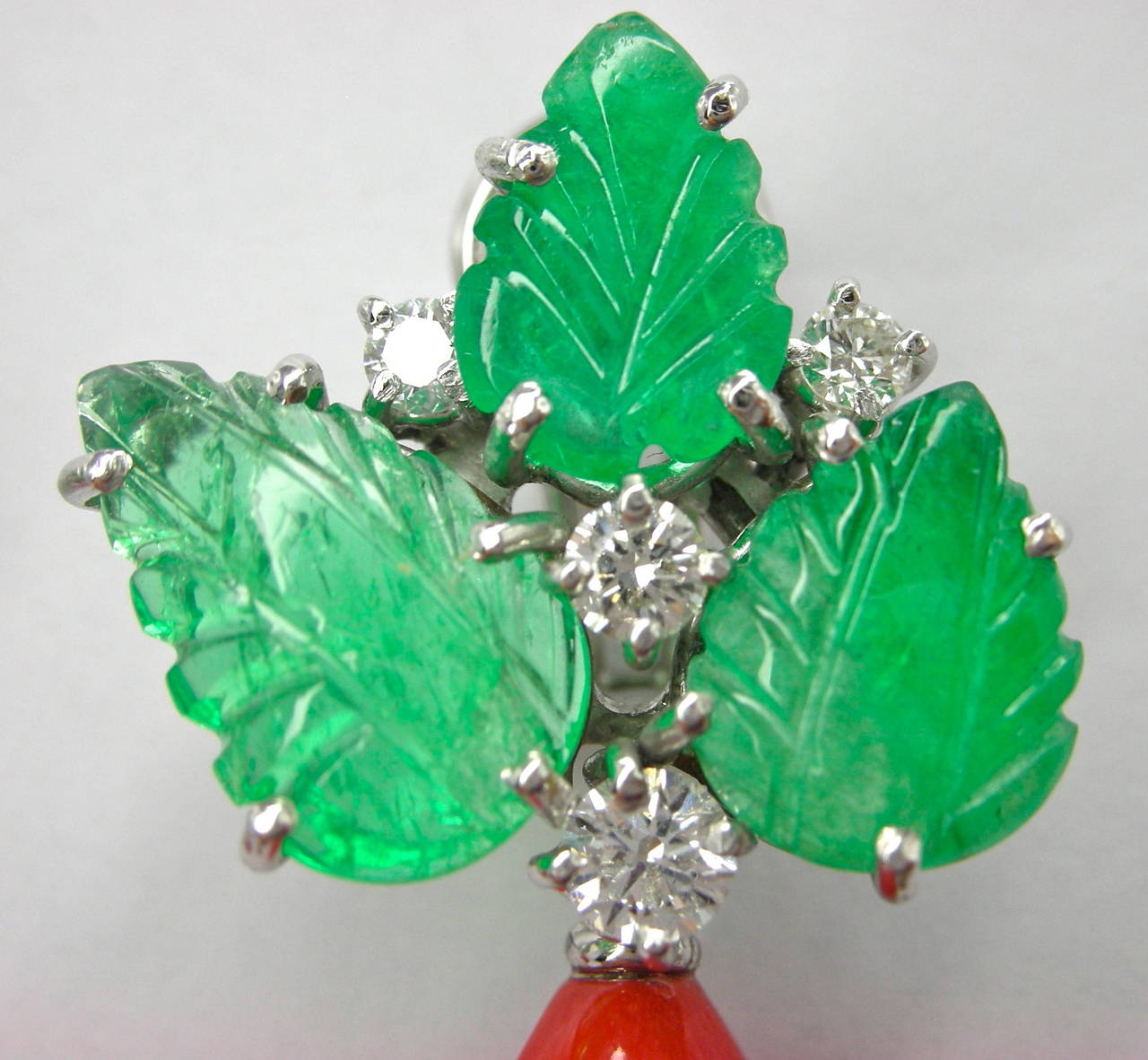 Pair of important Earrings featuring  Mediterranean warm red coral drops, engraved emerald leaves weighing 10.06 carats and 0.75 carats of brilliant cut diamonds mounted in 18k white gold. Hand crafted in Italy by Jona