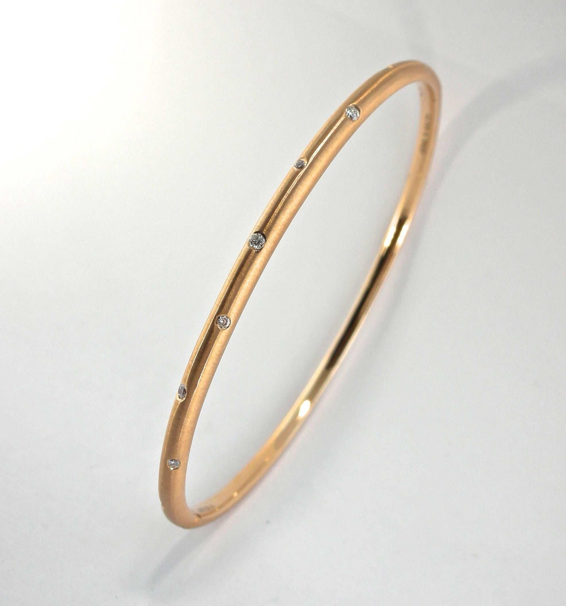 Alex Jona design collection, hand crafted in Italy, 18 karat brushed rose gold bangle bracelet set with 9 white diamonds, weighing 0.14 carats in total, F color, VS2 clarity.

Alex Jona jewels stand out, not only for their special design and for the