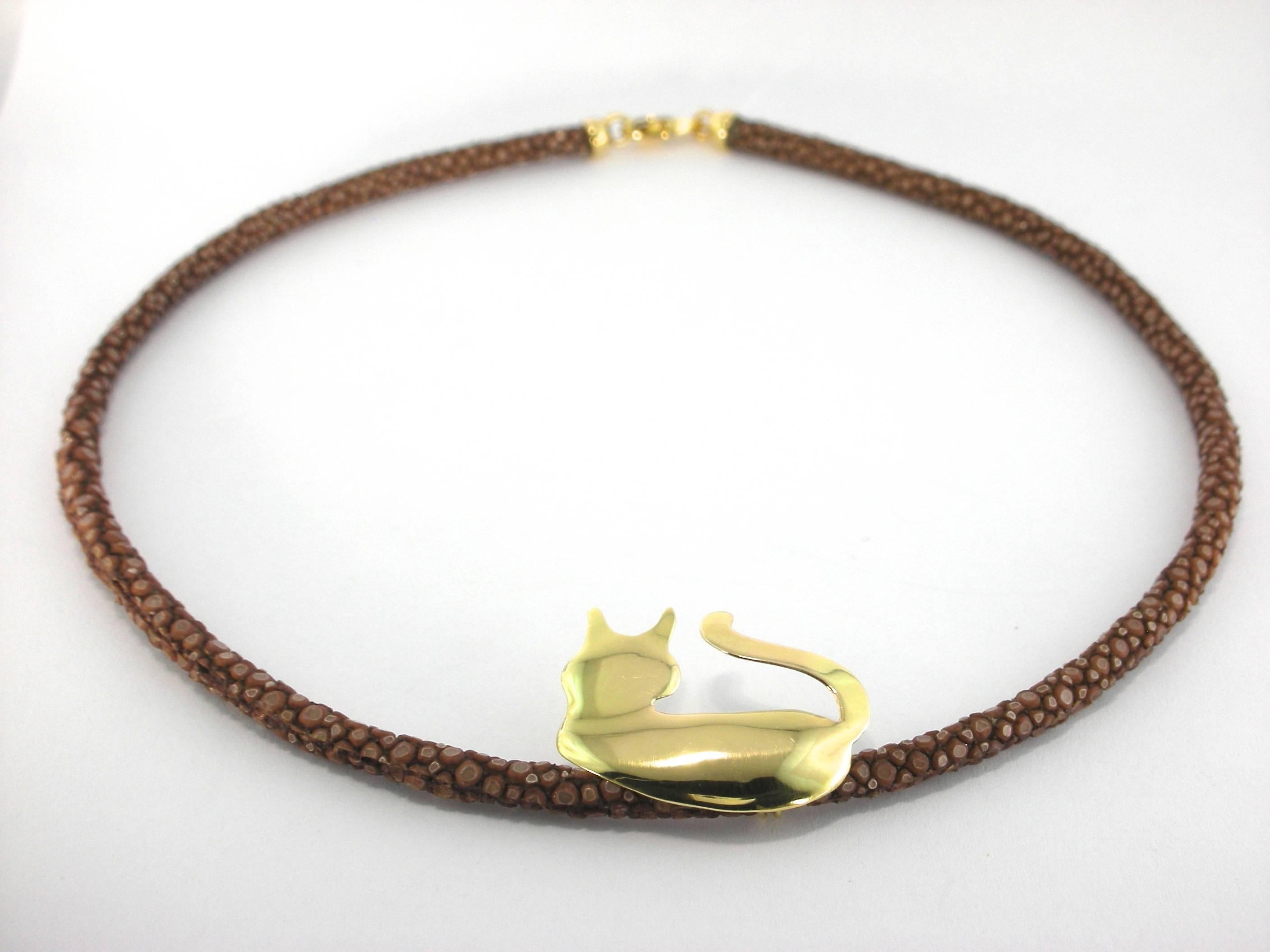 Jona design collection, hand crafted in Italy,18 karat yellow gold cat silhouette pendant with brown galuchat choker (16 inch long).

All Jona jewelry is new and has never been previously owned or worn. Each item will arrive at your door beautifully