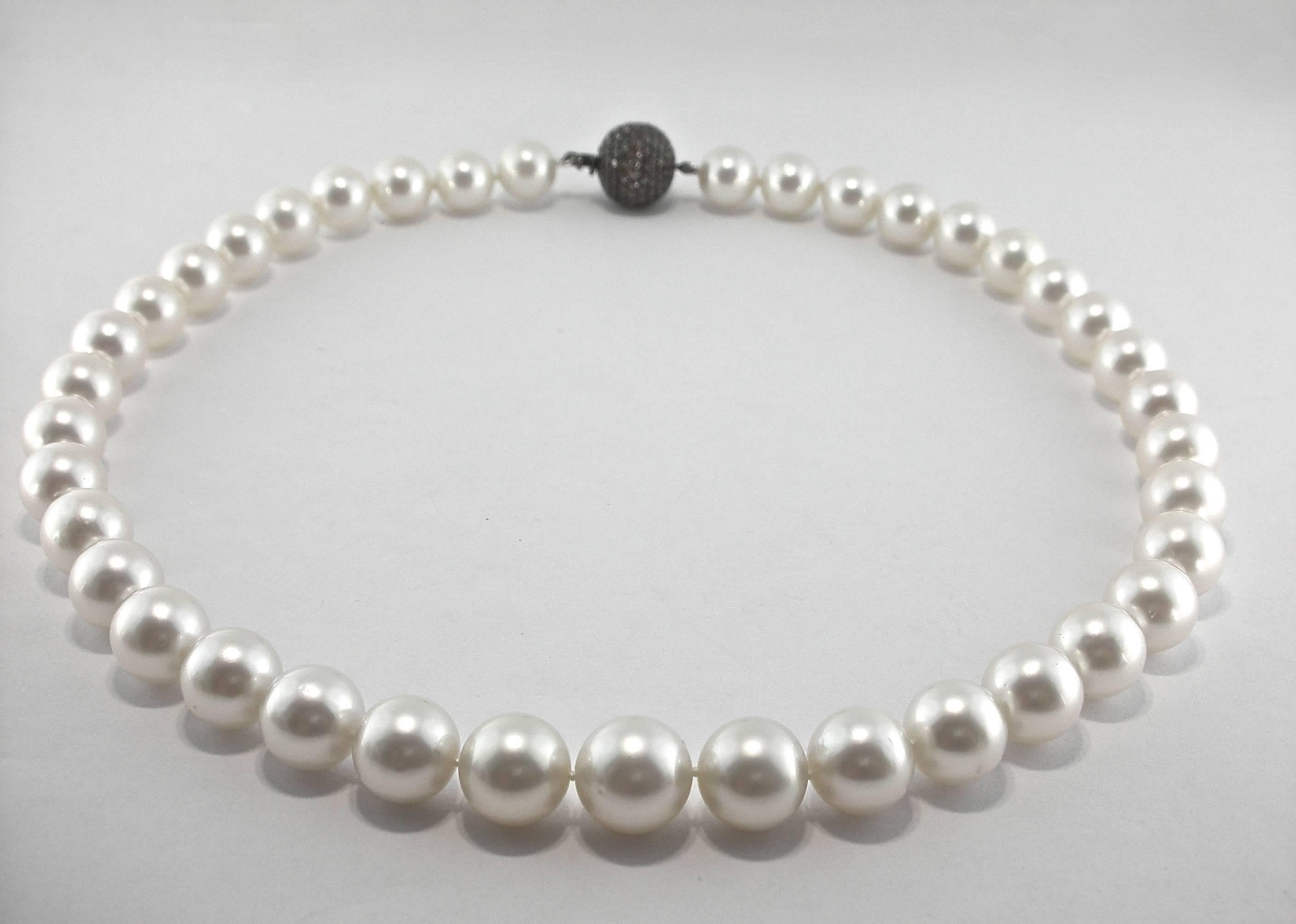Jona South Sea pearl necklace ( total length 18.5 inch/47 cm), composed of 39 cultured South Sea pearls ranging from  10.2 to 12.7 mm in diameter, strung on a hand-knotted silk cord and secured by a brown diamond pavé ball clasp (212 pieces, ct.