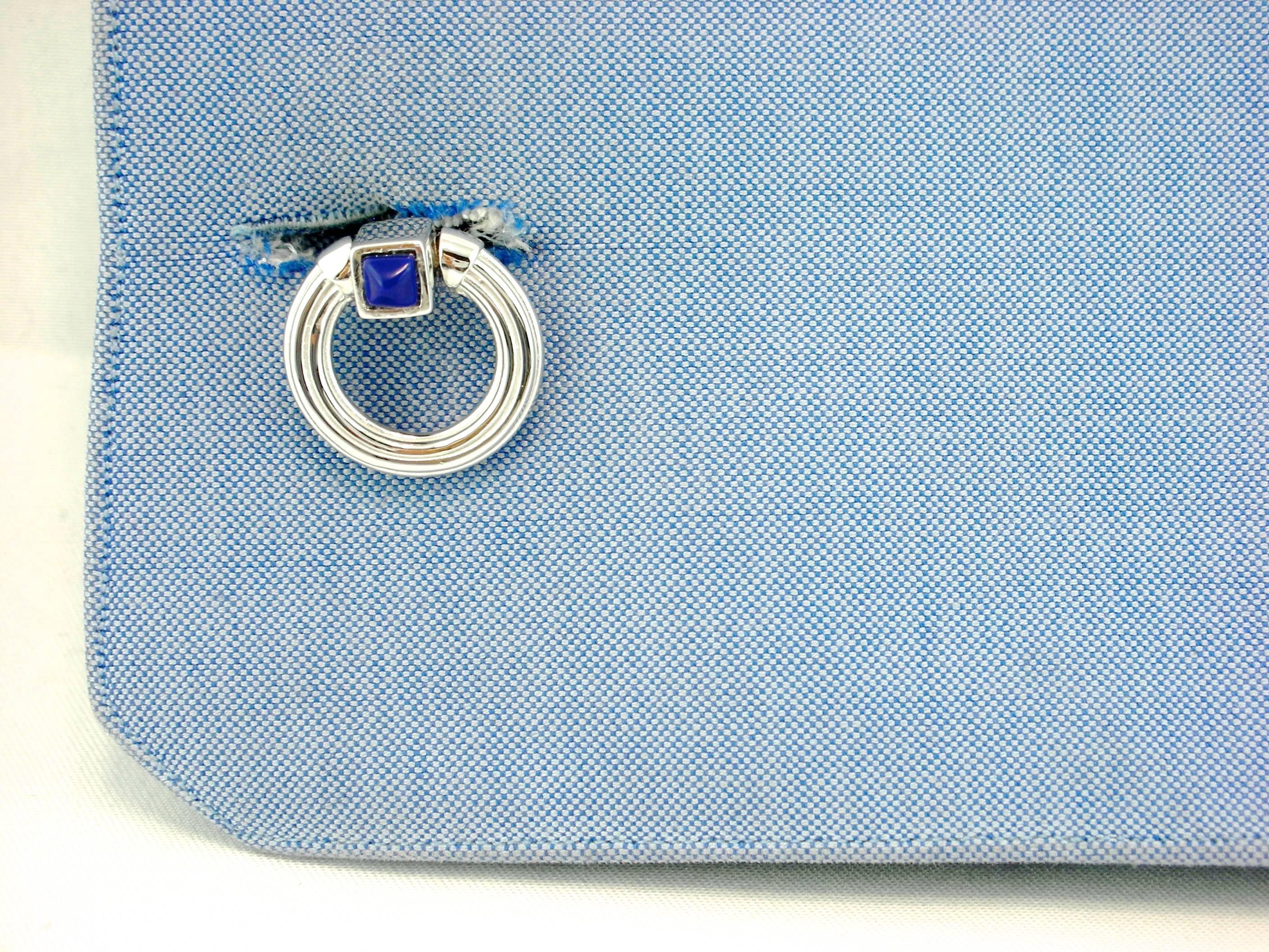 Jona design collection, hand crafted in Italy, rhodium plated sterling silver double ring folding cufflinks with Lapis cabochons. Marked JONA 925.
These links push through the shirt cuff and fold down either side to keep them locked in tightly. 
All