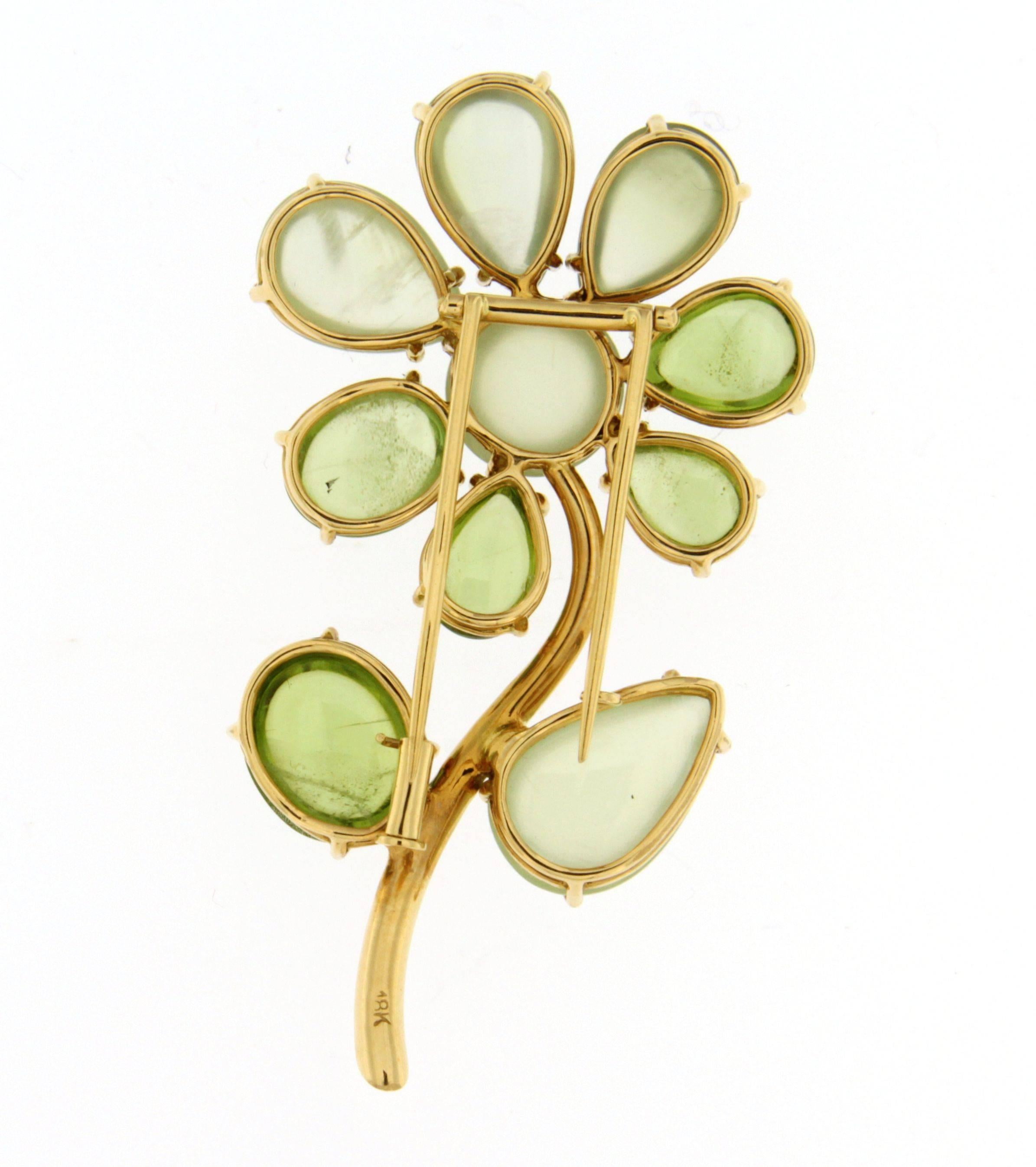 Jona design collection, hand crafted in Italy, 18 karat yellow gold flower brooch, showcasing 31.77 total carats of cabochon peridots and prehnites, enriched with a white diamond at the stem base.  
All Jona jewelry is new and has never been