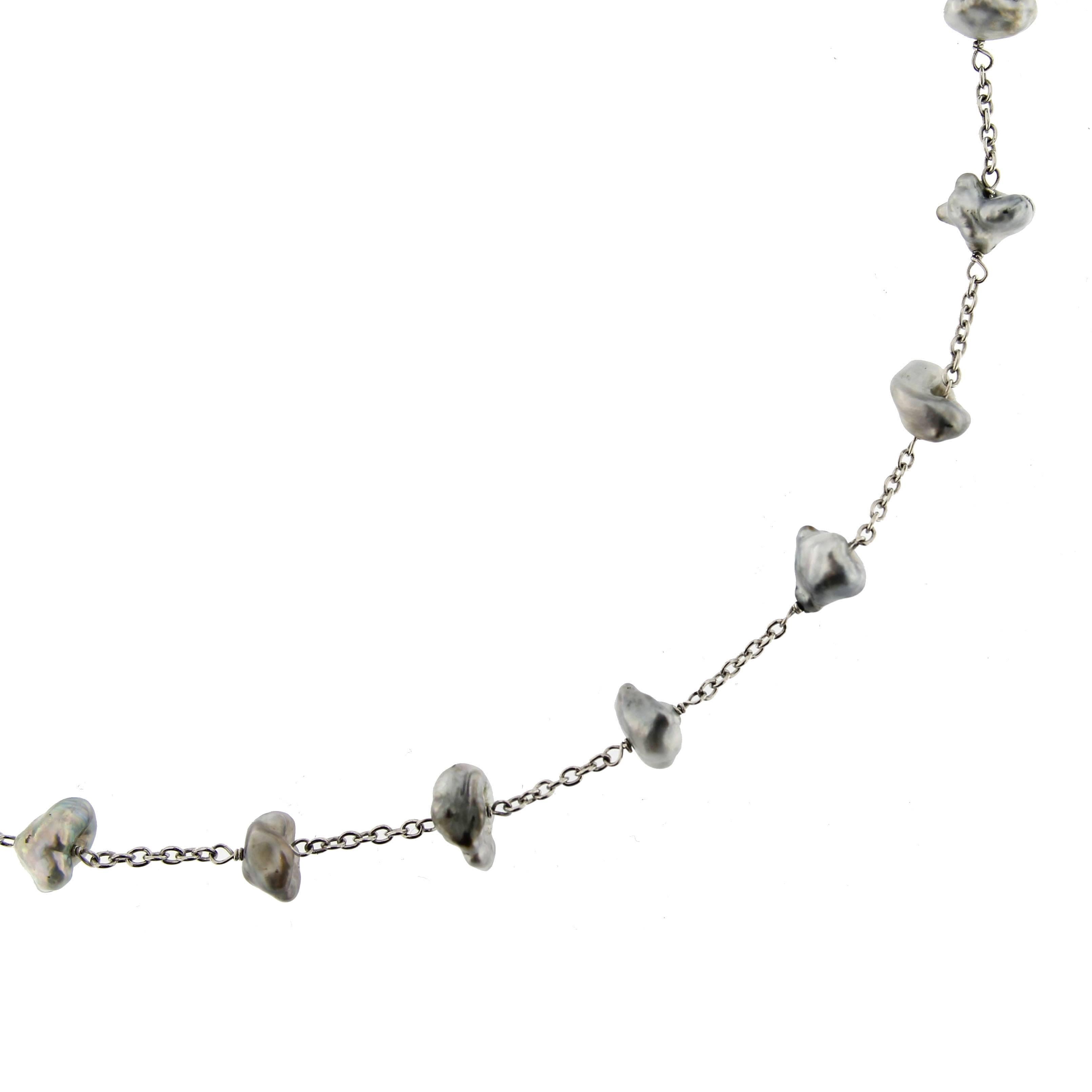 Alex Jona design collection, hand crafted in Italy, 18 karat white gold, 17.71 in/ 45 cm long necklace with 23 Tahiti Keshi grey pearls.

Alex Jona jewels stand out, not only for their special design and for the excellent quality of the gemstones,