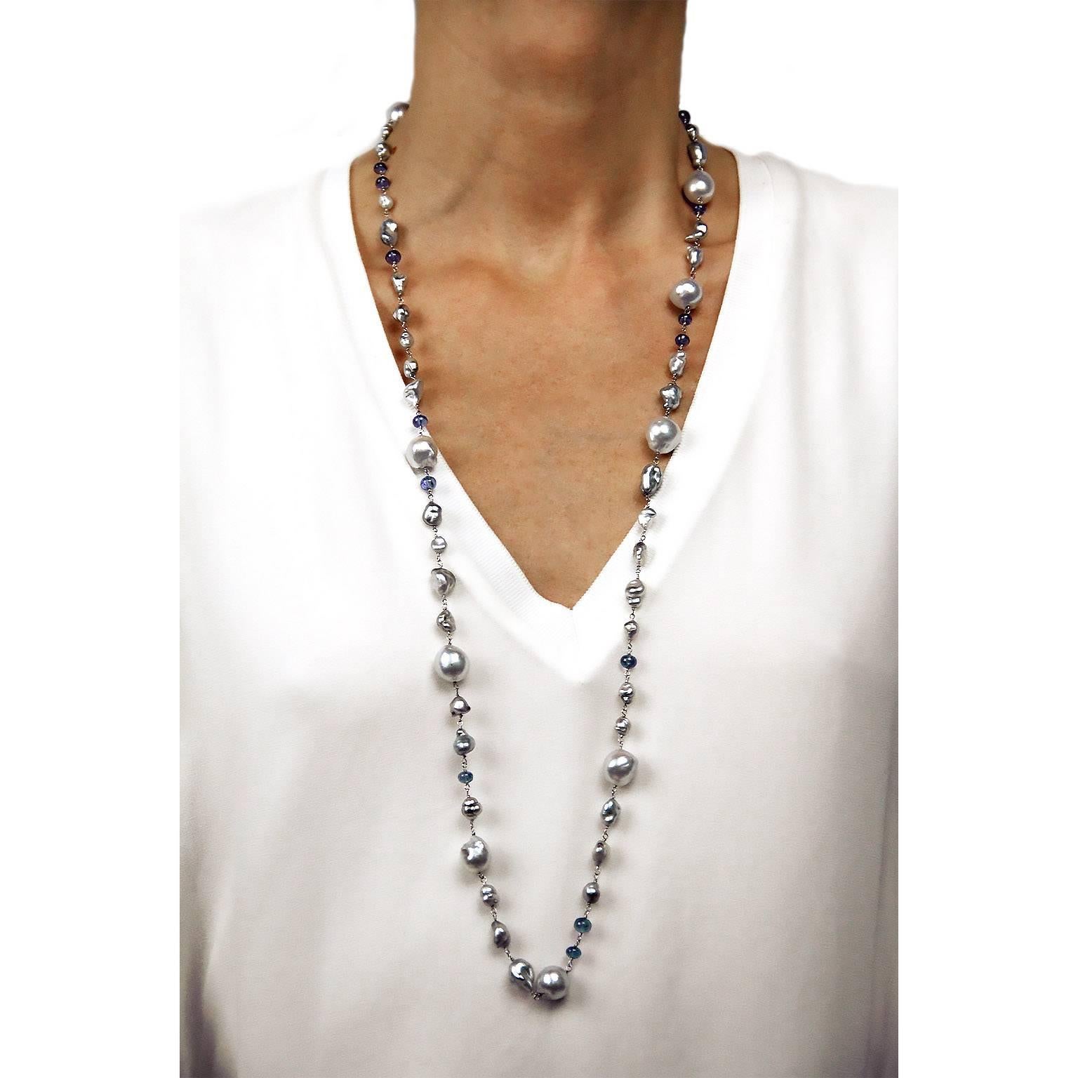 Jona design collection, hand crafted in Italy, 18 karat white gold, 35.43 in / 90 cm long sautoir necklace featuring 40 keshi grey Tahiti pearls, 9 baroque Tahiti grey pearls, alternating with 15 cabochon tanzanites.

All Jona jewelry is new and