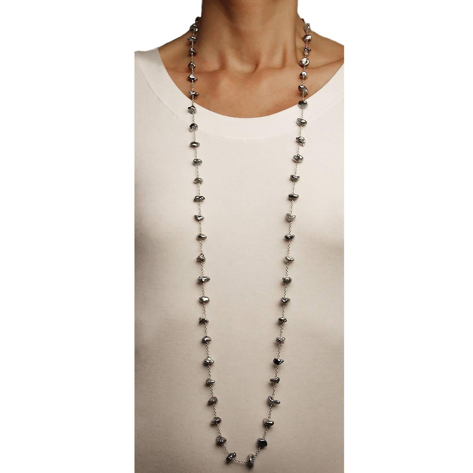 Jona design collection, hand crafted in Italy, 18 karat white gold, 51.18 in /130 cm long sautoir necklace featuring 59 keshi light grey Tahiti pearls.
All Jona jewelry is new and has never been previously owned or worn. Each item will arrive at