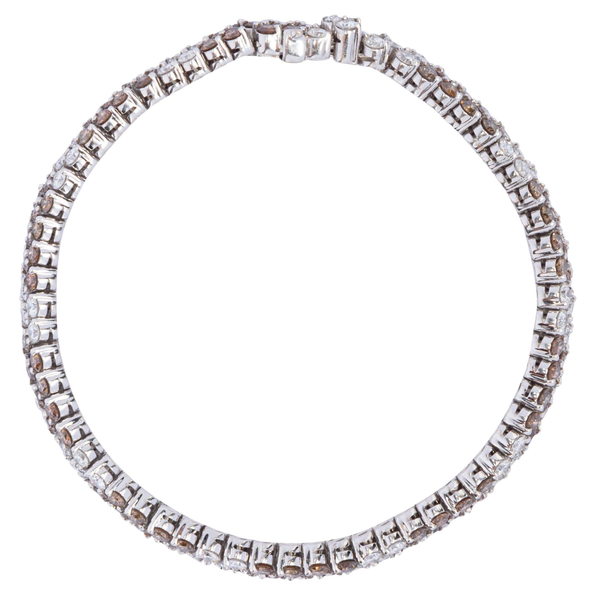 Alex Jona design collection, hand crafted in Italy, 18 Karat white gold bracelet set with alternating white and champagne round cut diamonds, it features 7.73 carats of champagne diamonds and 4.22 carats of white diamonds. The bracelet measures 18.5