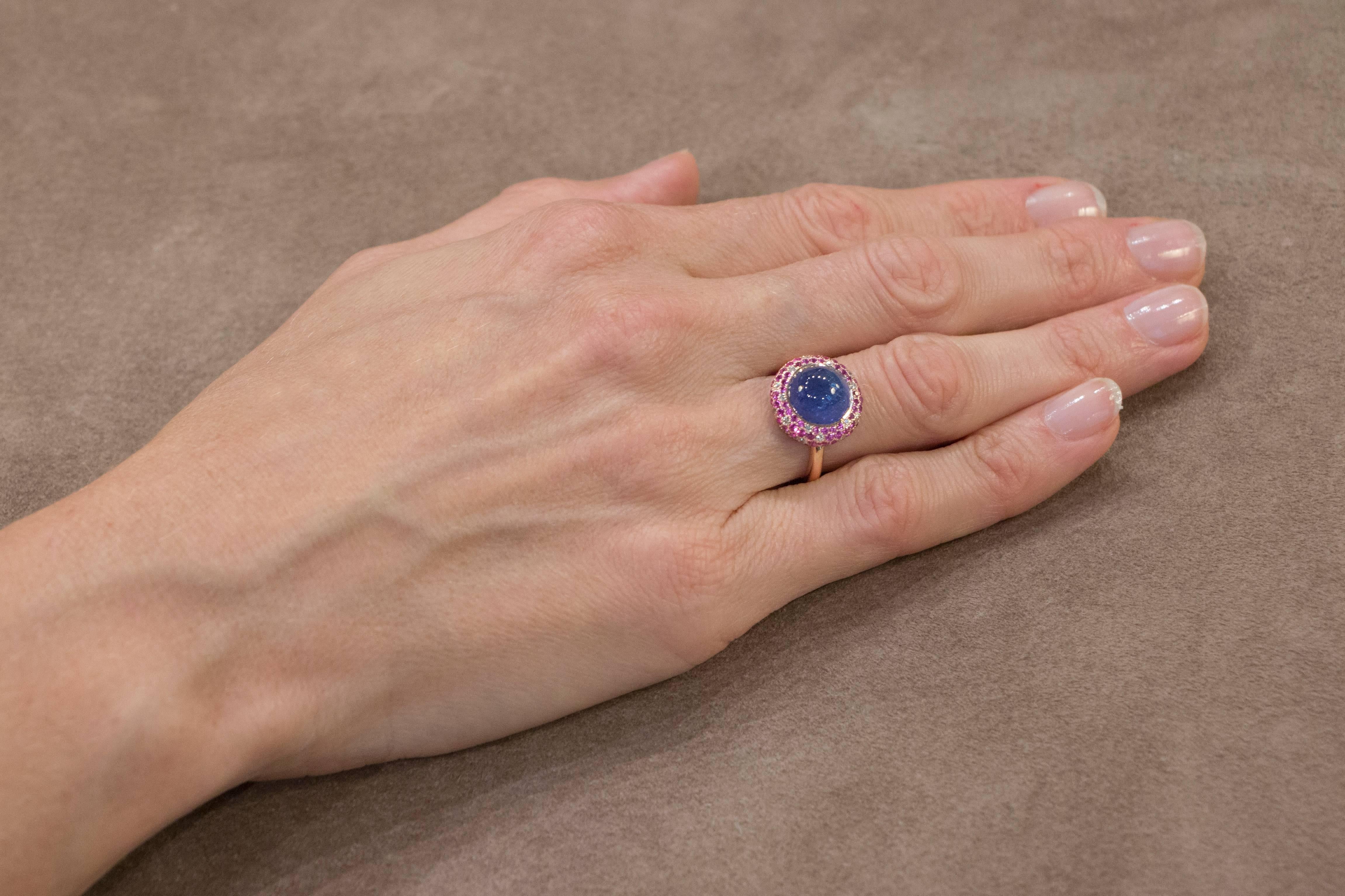 Jona design collection, hand crafted in Italy, 18 karat rose gold ring, centering a cabochon cut Tanzanite weighing 4.95 carats, surrounded by 80 pink sapphires weighing 0.91 carats and 20 white diamonds weighing 0.18 carats. Signed Jona.  US size: