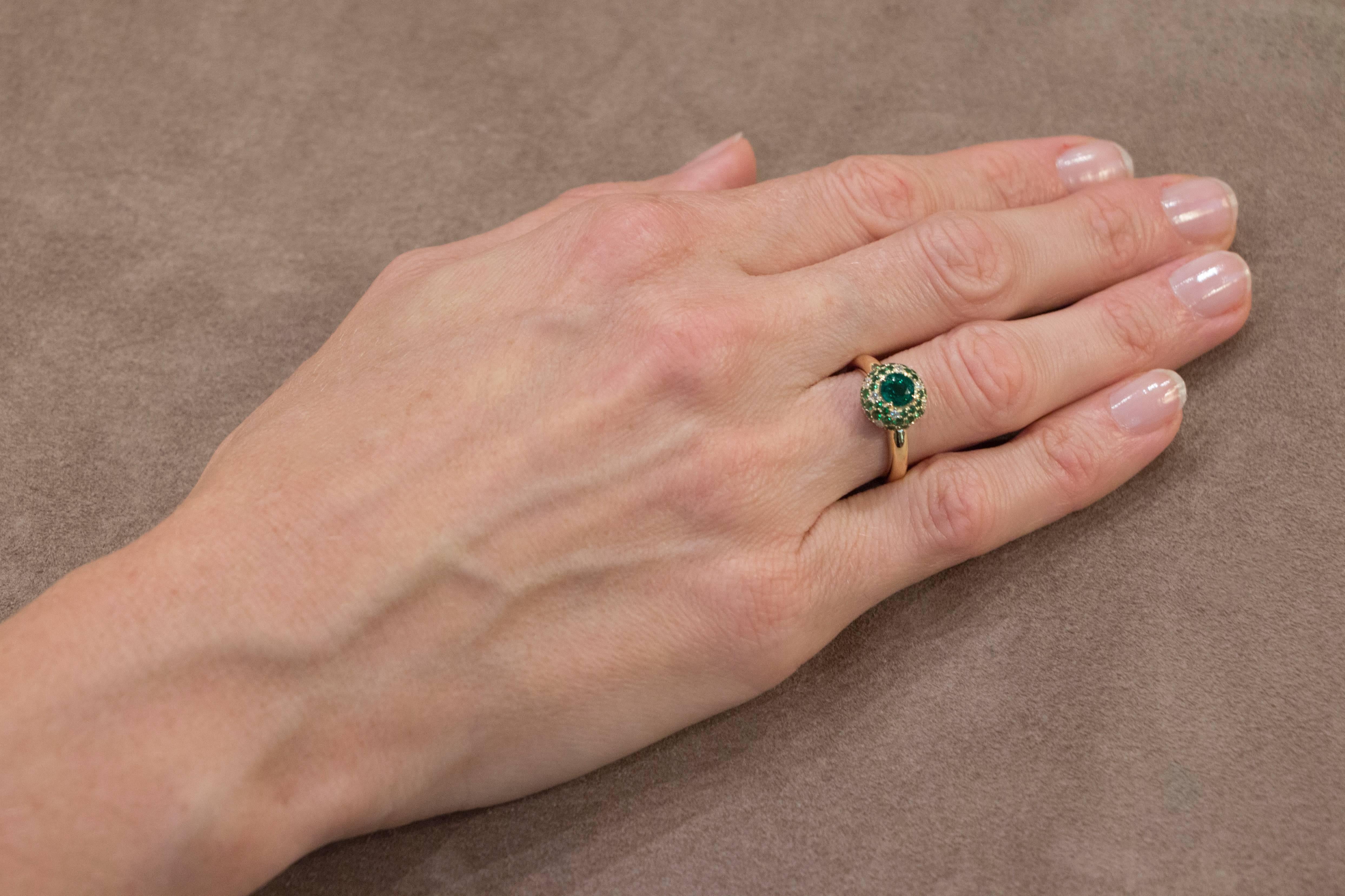 Jona design collection, hand crafted in Italy, 18 karat yellow gold ring centering a round cut Emerald weighing 0.60 carats, surrounded by a Tsavorite (1.17 carats) and white Diamond (0.19 carats) pavé. 
Ring Size: US 6 /EU 12 (can be sized to any