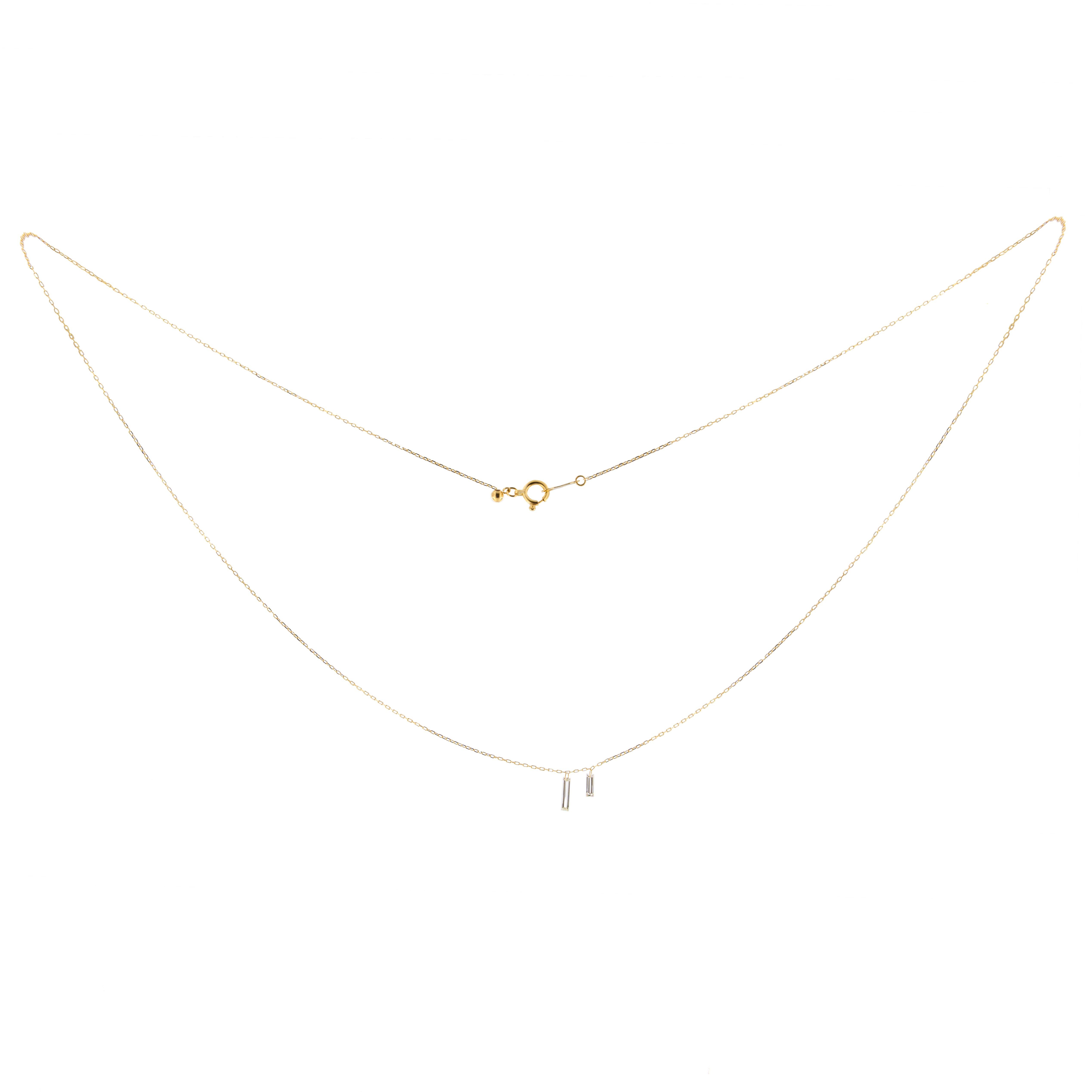 Jona design collection, hand crafted in Italy, 18 karat yellow gold Necklace suspending 2 drilled Baguette cut White Diamonds weighing 0.16 carats in total, G color,  VS2 clarity. Chain Length : 45 cm / 17. 71 in.
All Jona jewelry is new and has