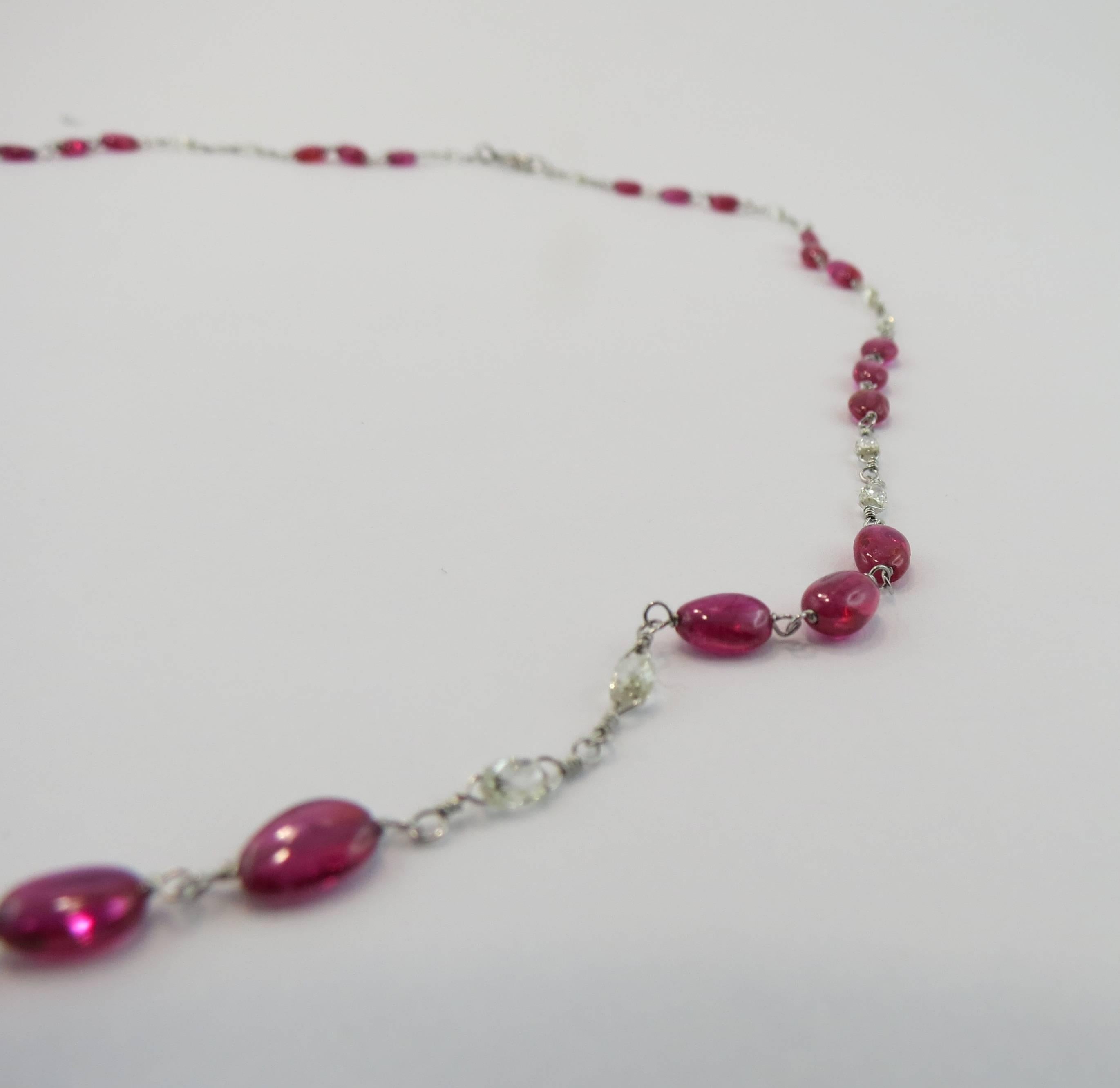 Jona Design Collection, hand crafted necklace, composed of 33 cabochon ruby beads weighing 11.13 carats set on a platinum chain with 22 oval briolette cut white diamonds weighing 1.69 carats in total.

All of our jewelry is new and has never been