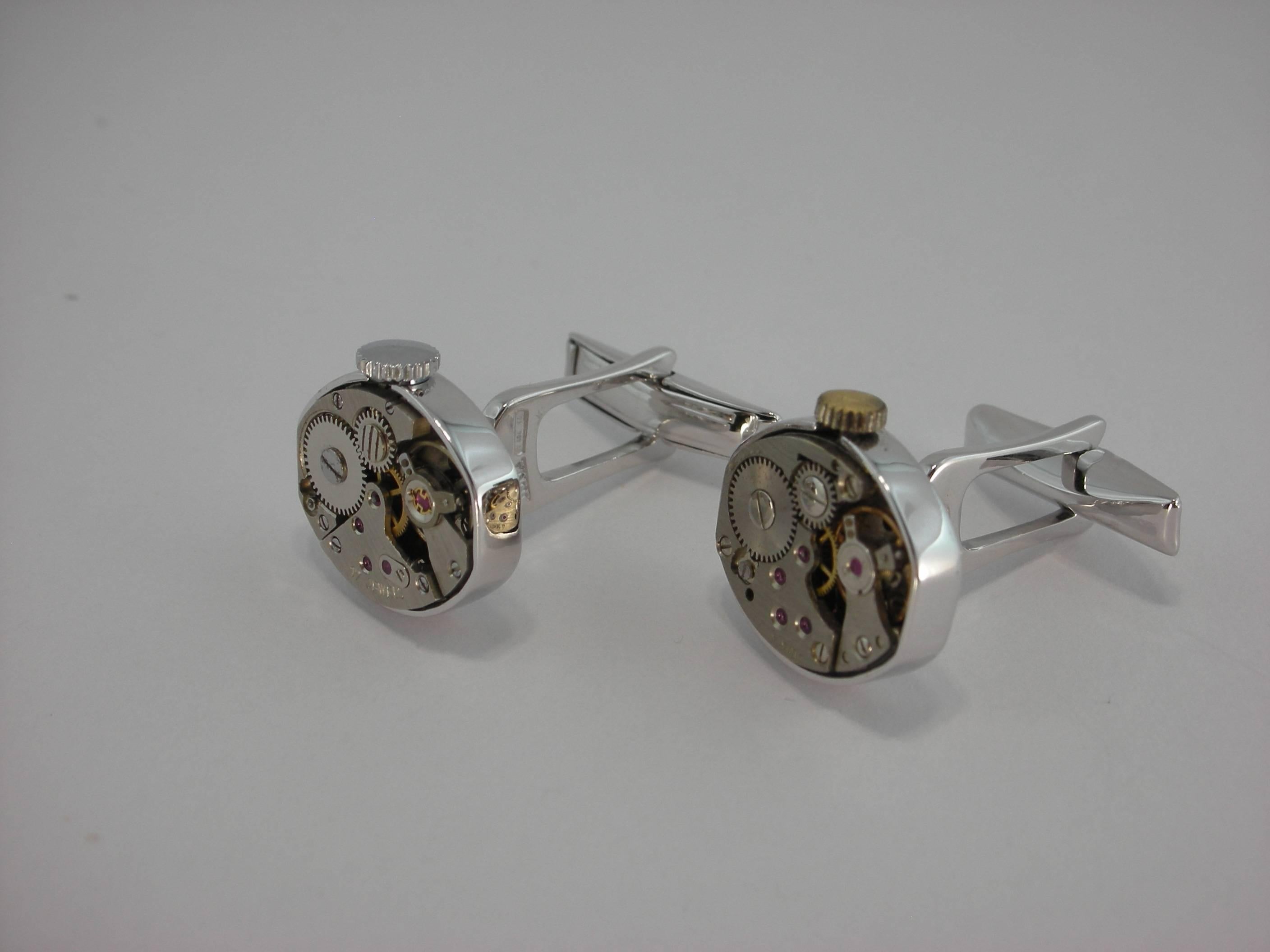 These rhodium plated sterling silver cufflinks, hand crafted in Italy by Jona, are actually built using genuine antique watch movements. 

All of our jewelry is new and has never been previously owned or worn.