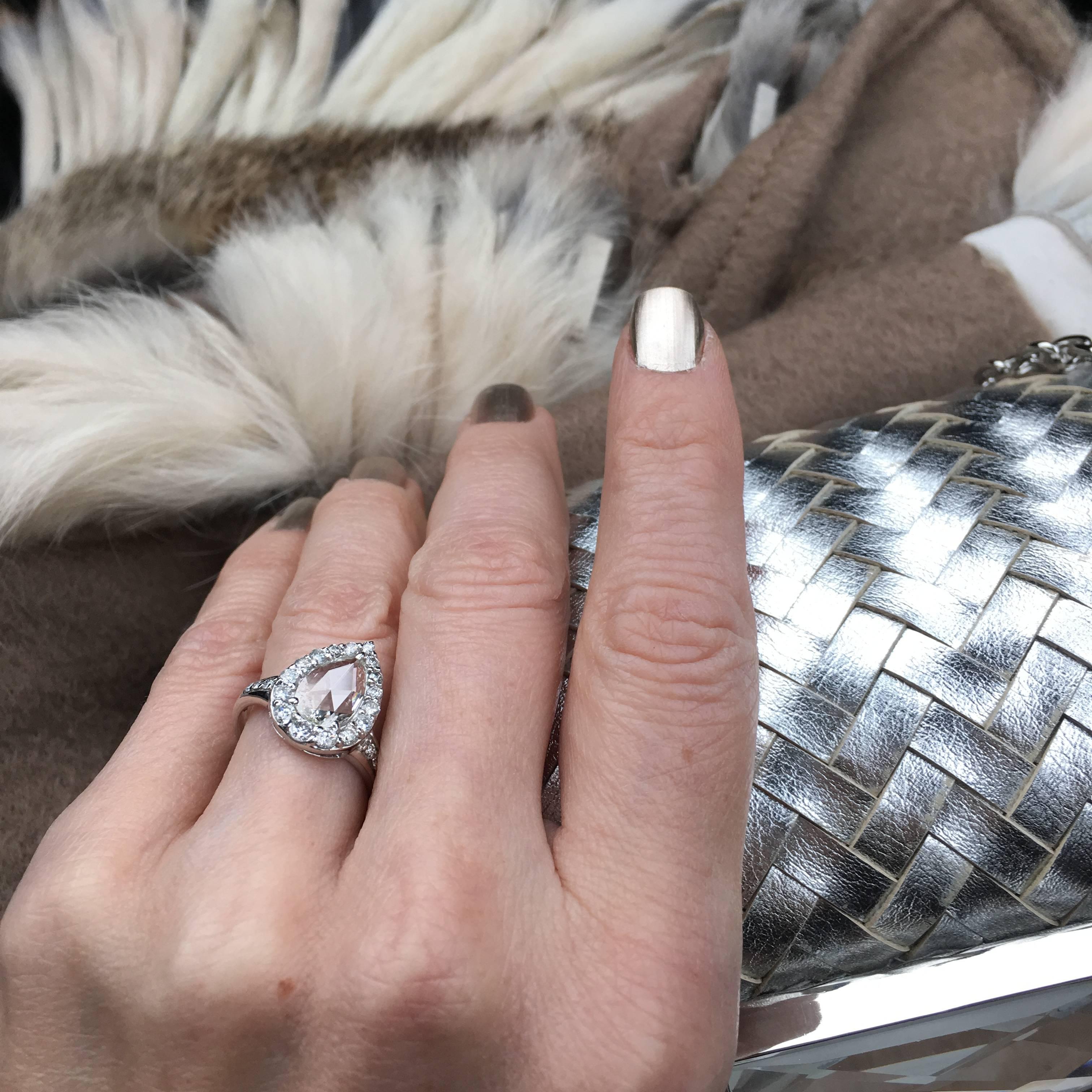 A true wow diamond ring!  This spectacular center Rose Cut Diamond is surrounded by white faceted round diamonds of graduated size, giving it a balanced and brilliant overall look.  Feminine, gorgeous and significant.   Set in 18kt White gold. 
